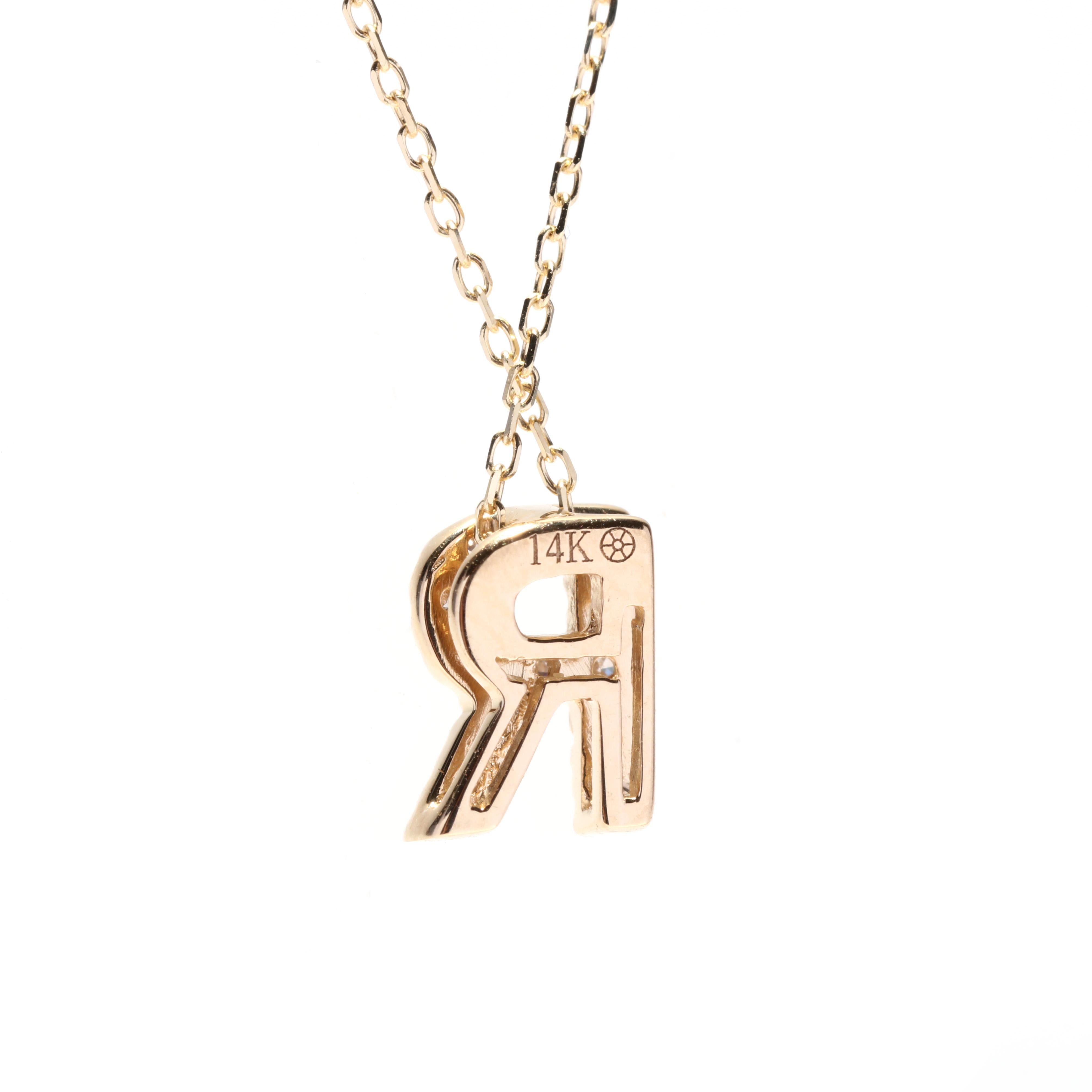 This 14K yellow gold necklace is adorned with a beautiful initial pendant in the shape of the letter R. The pendant features a diamond accent, adding a touch of sparkle and elegance to the piece. The necklace measures 16 inches in length, making it