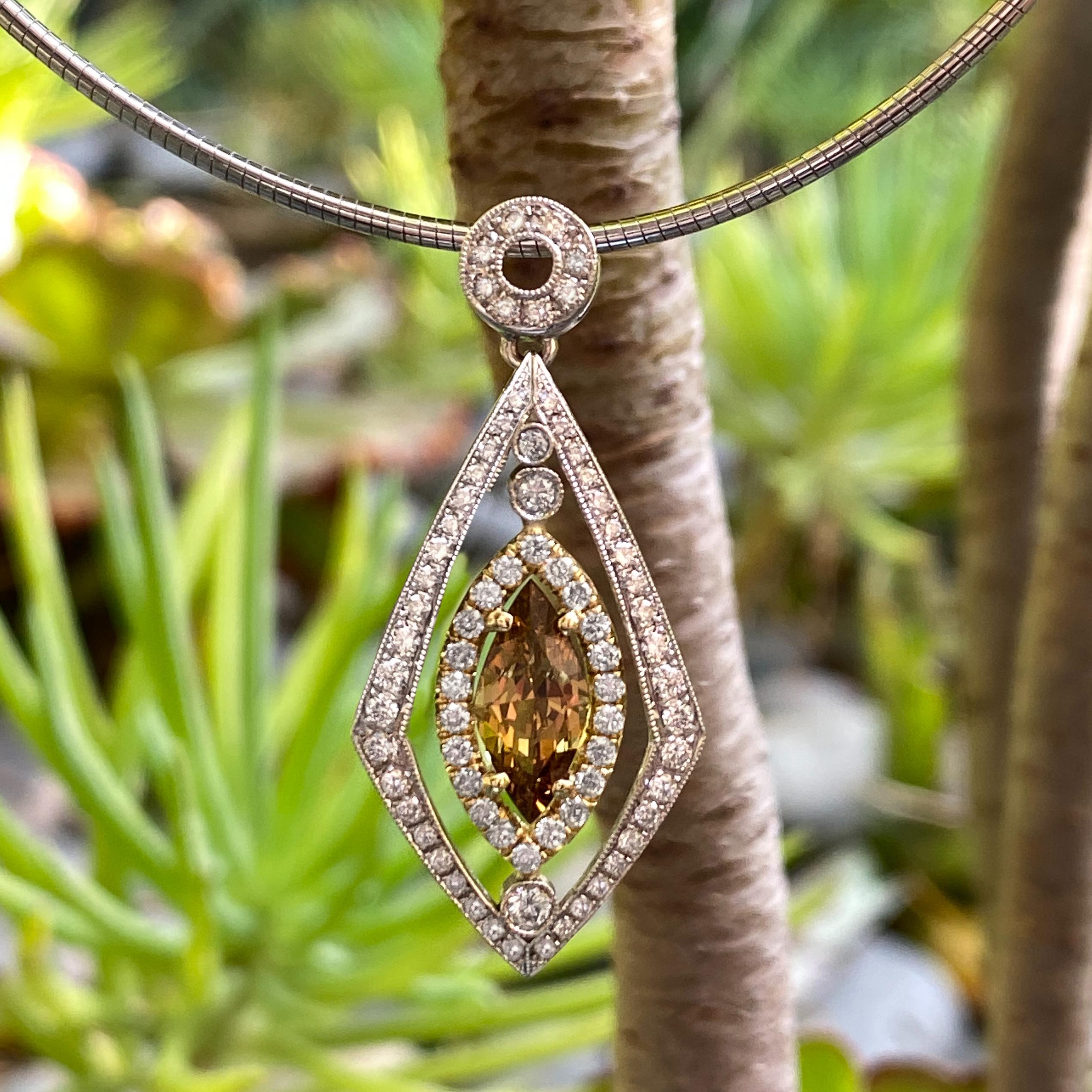 This gorgeous, sexy and modern pendant by Eytan Brandes features a 1.58 carat chrysoberyl floating in a navette-shaped frame of diamonds.

The Madagascar chrysoberyl, in a rich shade of root beer brown with strong golden yellow undertones, has a