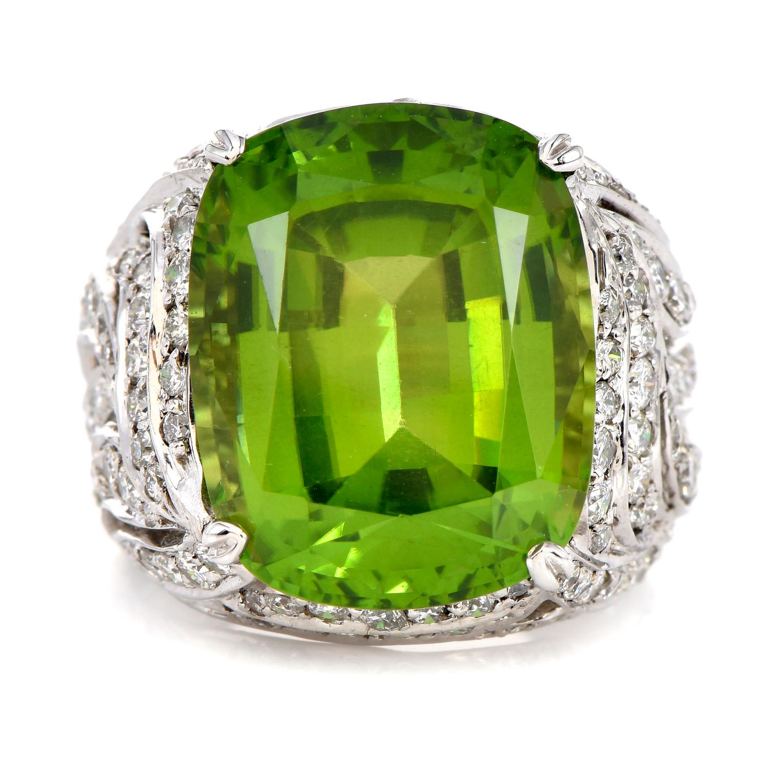 THIS 1980'S  Diamond & Peridot Ring is inspired in a Leaf Open design and crafted in solid 18K White Gold.Prominently featured in the center is approximately 18.00 carats Peridot, Cushion Cut, Prong Set. Surrounding the piece, there are  100