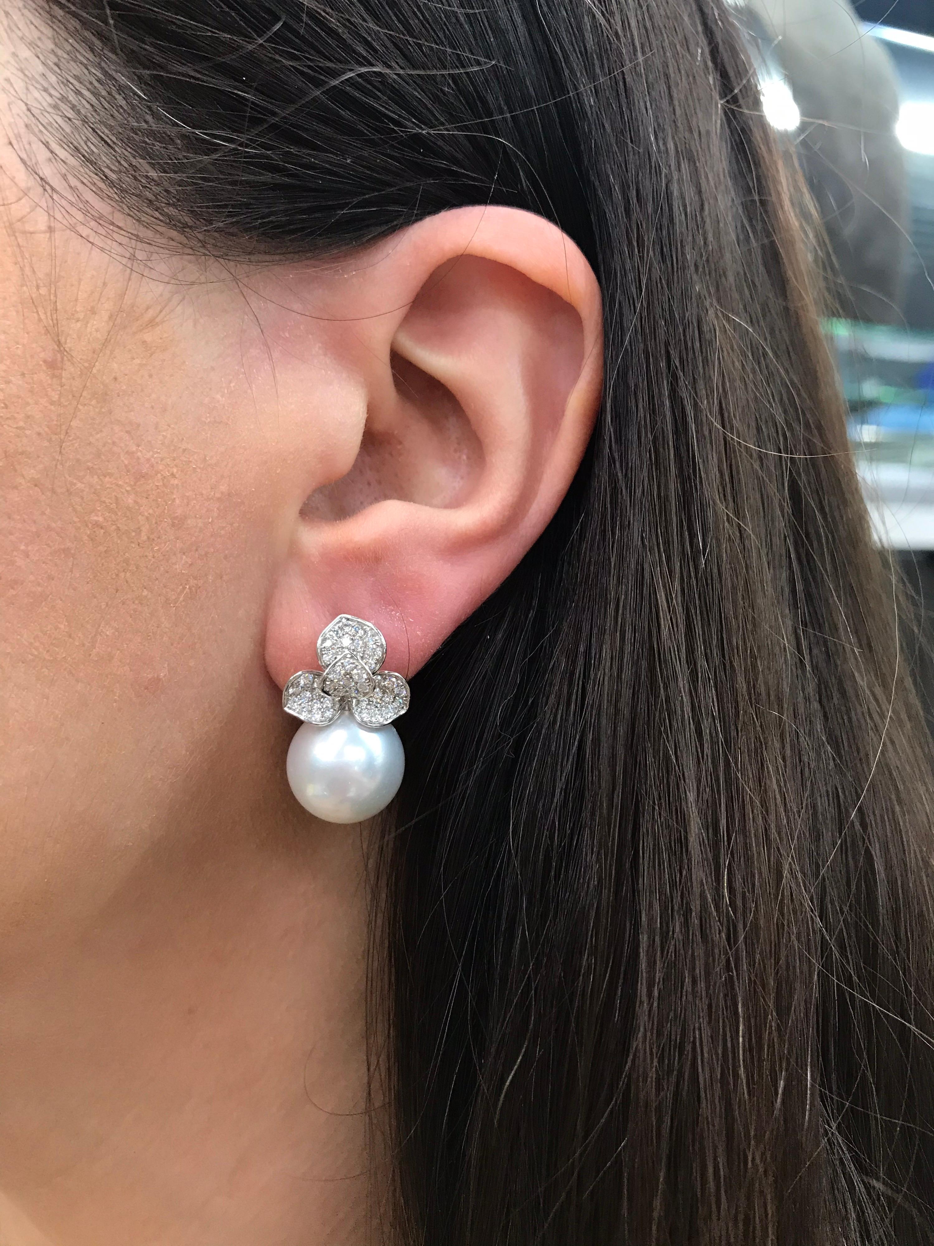 18K White gold petal drop earrings featuring two South Sea measuring 13-14 mm with 96 round brilliants weighing 0.98 carats. 
Color G-H
Clarity SI