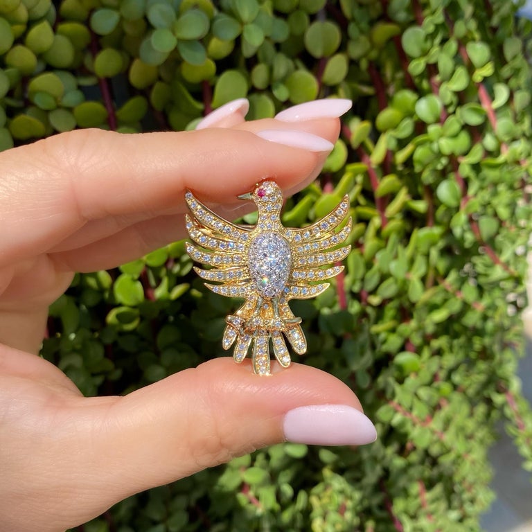 Simply Beautiful! Enchanting and finely detailed Phoenix Bird Diamond encrusted Phoenix Bird with a Ruby eye Brooch Pendant. Hand set with Diamonds, approx. 1.50 total carat weight. Hand crafted in Platinum and 18K Yellow Gold for an Awesome effect.
