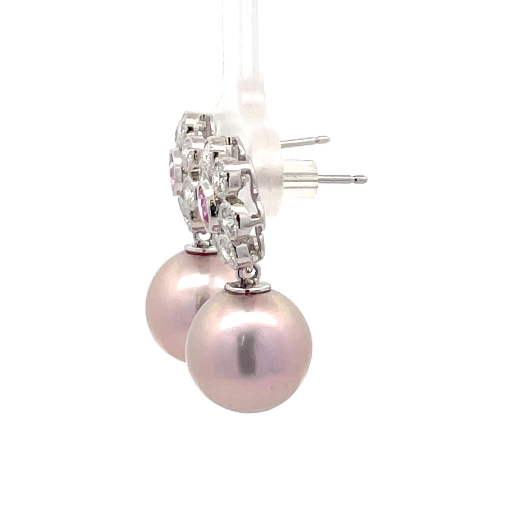 14 Karat White Gold drop earrings featuring two Pink Sapphires weighing 0.40 Carats surrounded by 14 round brilliants, 0.40 carats, and two pink Freshwater pearls measuring 10-11 MM.

Pearls earrings can be changed to Tahitian, Pink, Gold or South