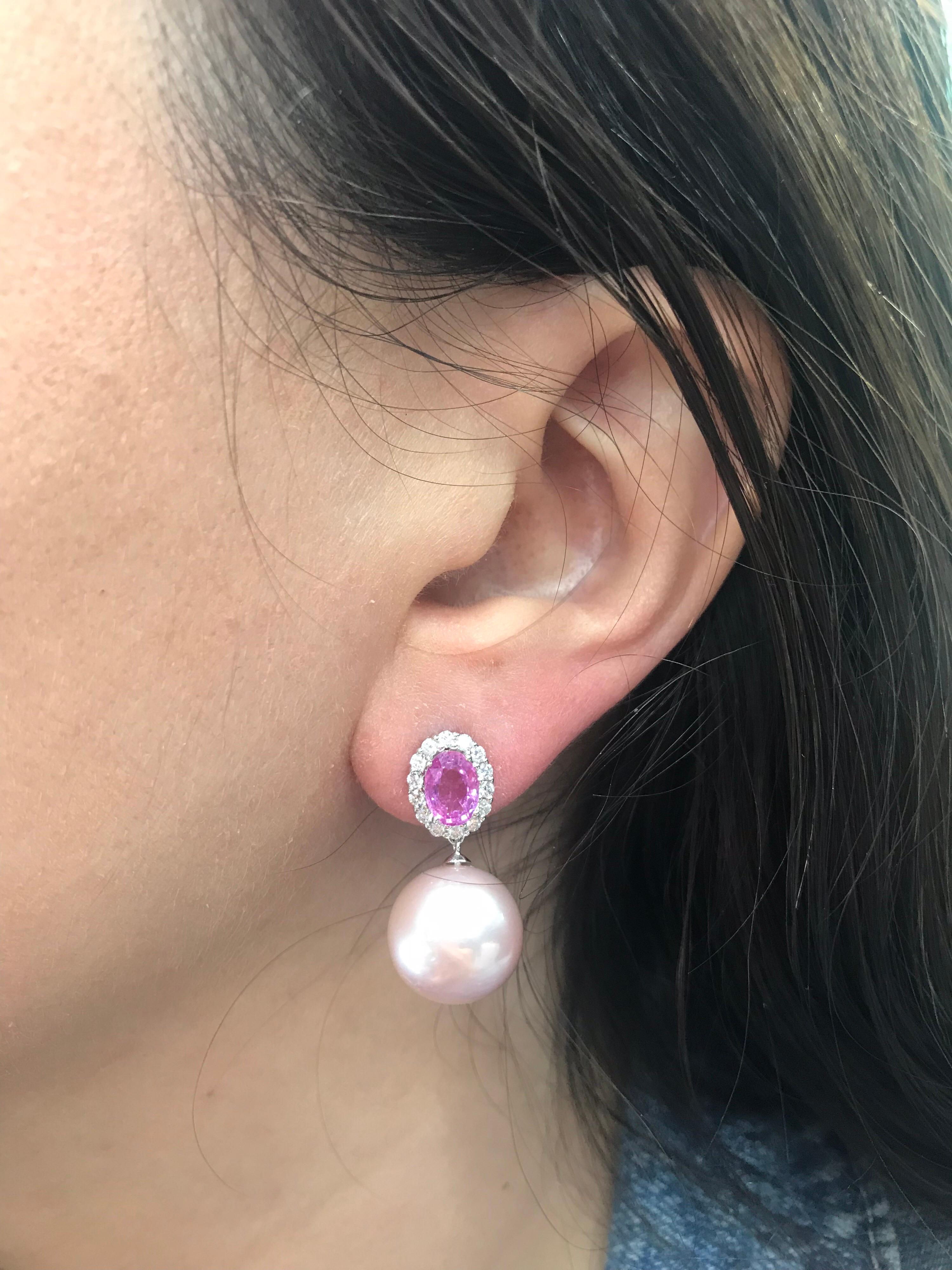18K White gold drop earrings featuring two oval shape pink sapphires, 1.85 carats, flanked with round brilliants 0.47 carats and two Pink Freshwater pearls measuring 13-14 mm. 