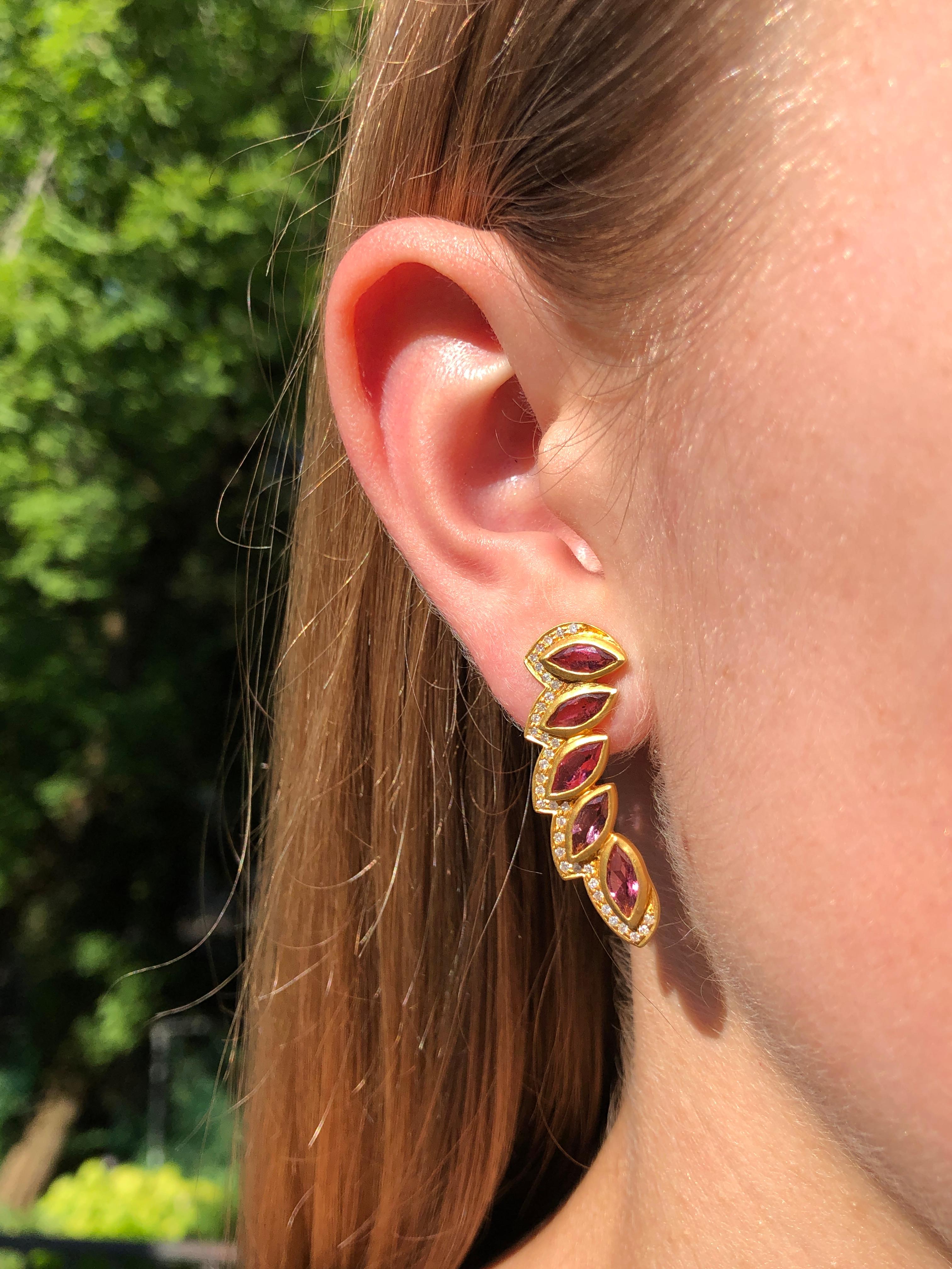 Pink Tourmaline Marquis stones surrounded by .33cts Diamonds set in 18kt matte Gold. Tourmaline is bright and vivid pink. Posts come with large backings that make these earrings secure and easy to love.  Flattering on all.