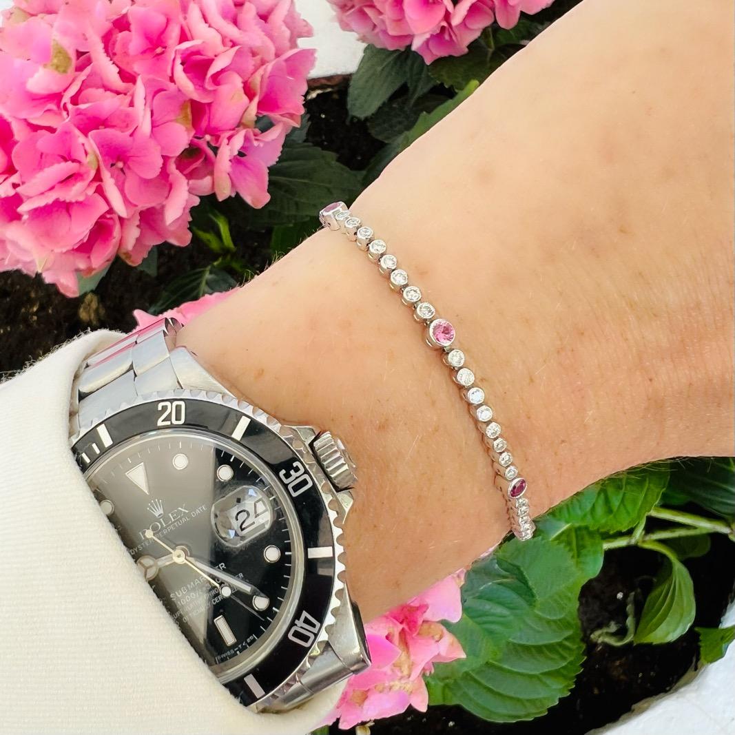 Delicate with spark and flashes of color, this platinum diamond and tourmaline line bracelet is a great addition to your collection. Perfect to wear everyday, and even better to add as pop of pink to a fancy dress affair. Designed with 62 round