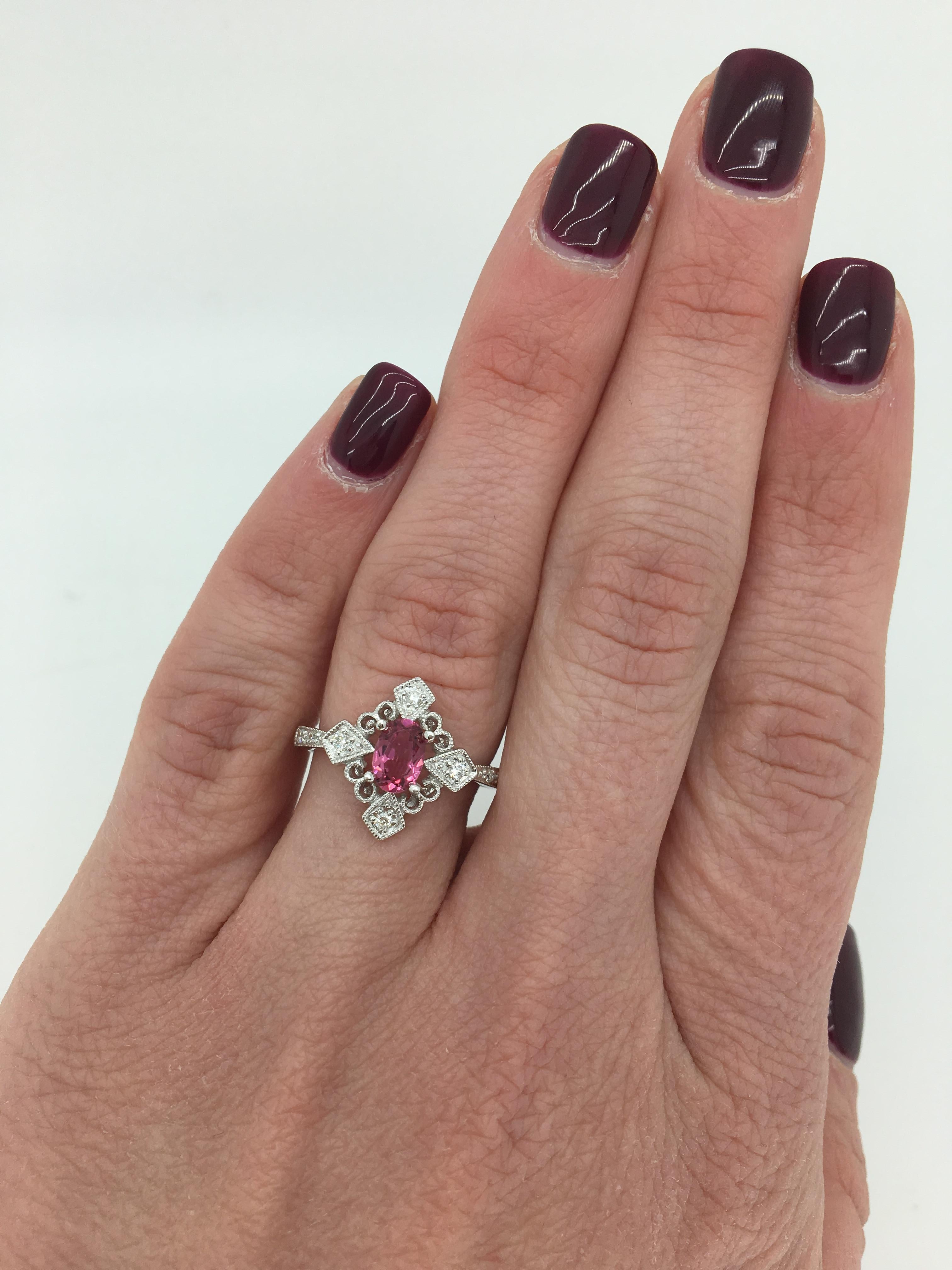Vintage inspired Pink Tourmaline & Diamond ring with ornate filigree detail crafted in 14k white gold.

Gemstone: Pink Tourmaline & Diamond
Gemstone Carat Weight: Approximately 4.10x6.08mm Pink Tourmaline
Diamond Carat Weight: Approximately