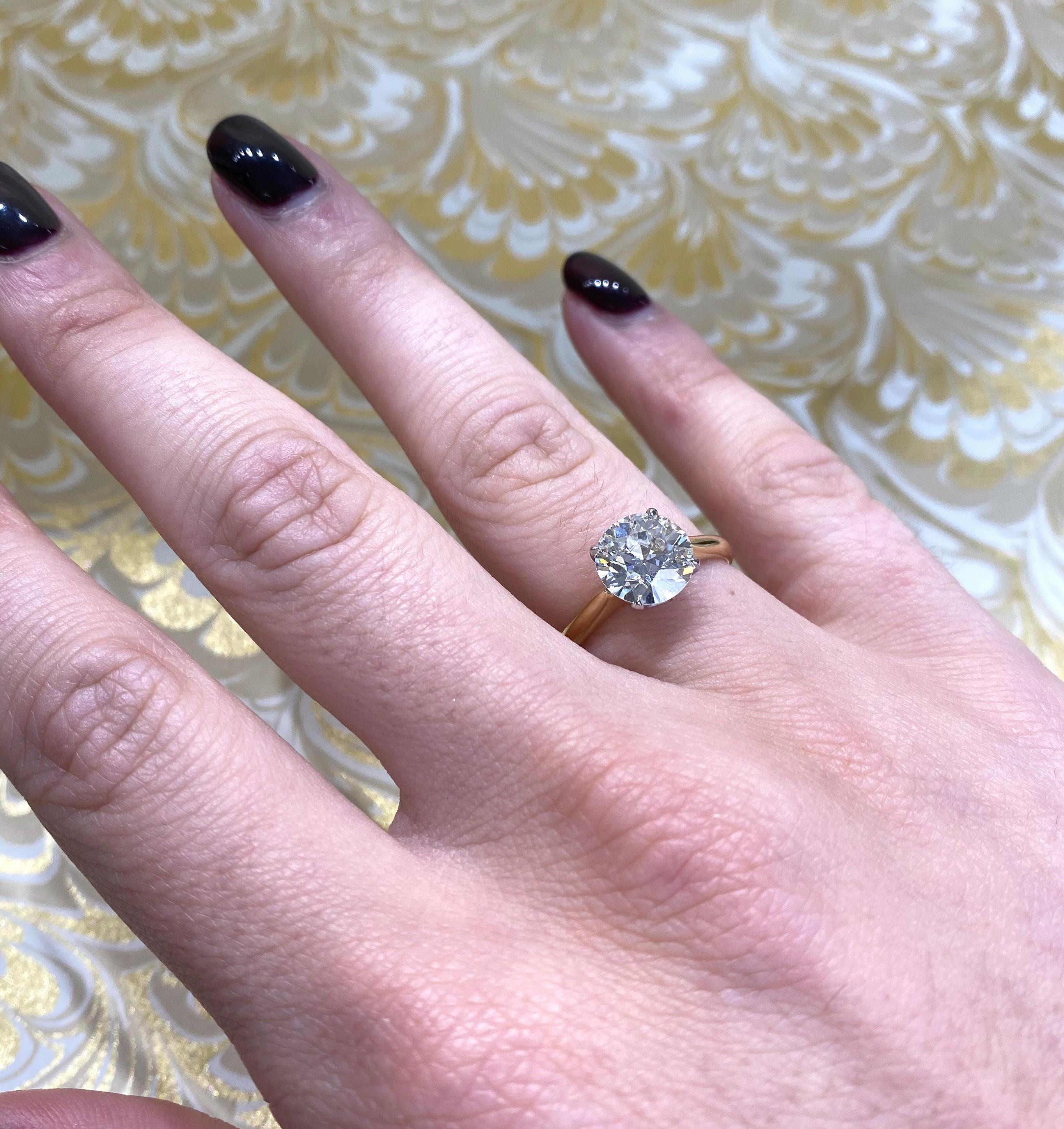 A solitaire diamond ring, set with a 2.05ct, J colour, VS1 clarity, Edwardian / old European-cut diamond, in a four claw platinum crown setting, on an 18ct yellow gold shank and bezel, with tapered shoulders, Hallmarked in London, 2020. Accompanied