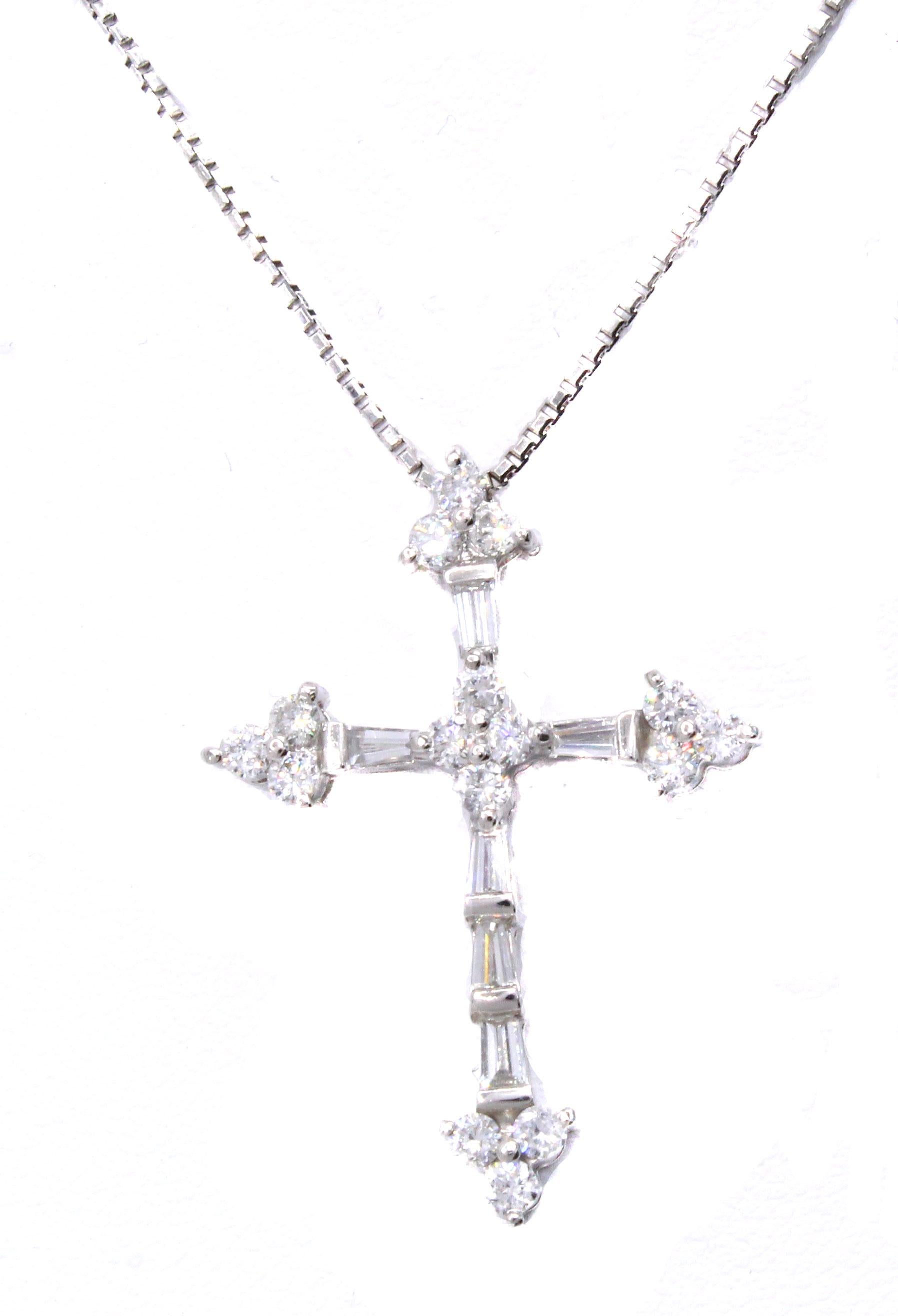 Beautifully designed and masterfully handcrafted this cross is set with 6 tapered baguette and 12 round brilliant cut diamonds with a total weight of 1 carat, which is stamped on the back of the pendant. All diamonds are perfectly matched in color
