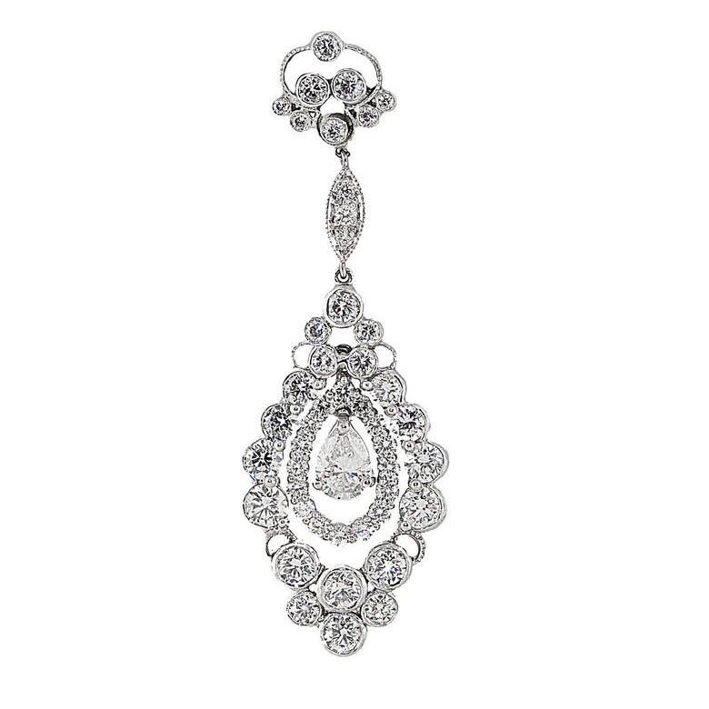 Art deco style, platinum chandelier dangle diamond earrings. The earrings have 8 carats total weight in diamonds. The center pear shape diamonds are approximately 0.70 carats each. The additional diamonds weigh 6.60 carats. All diamonds are G/H