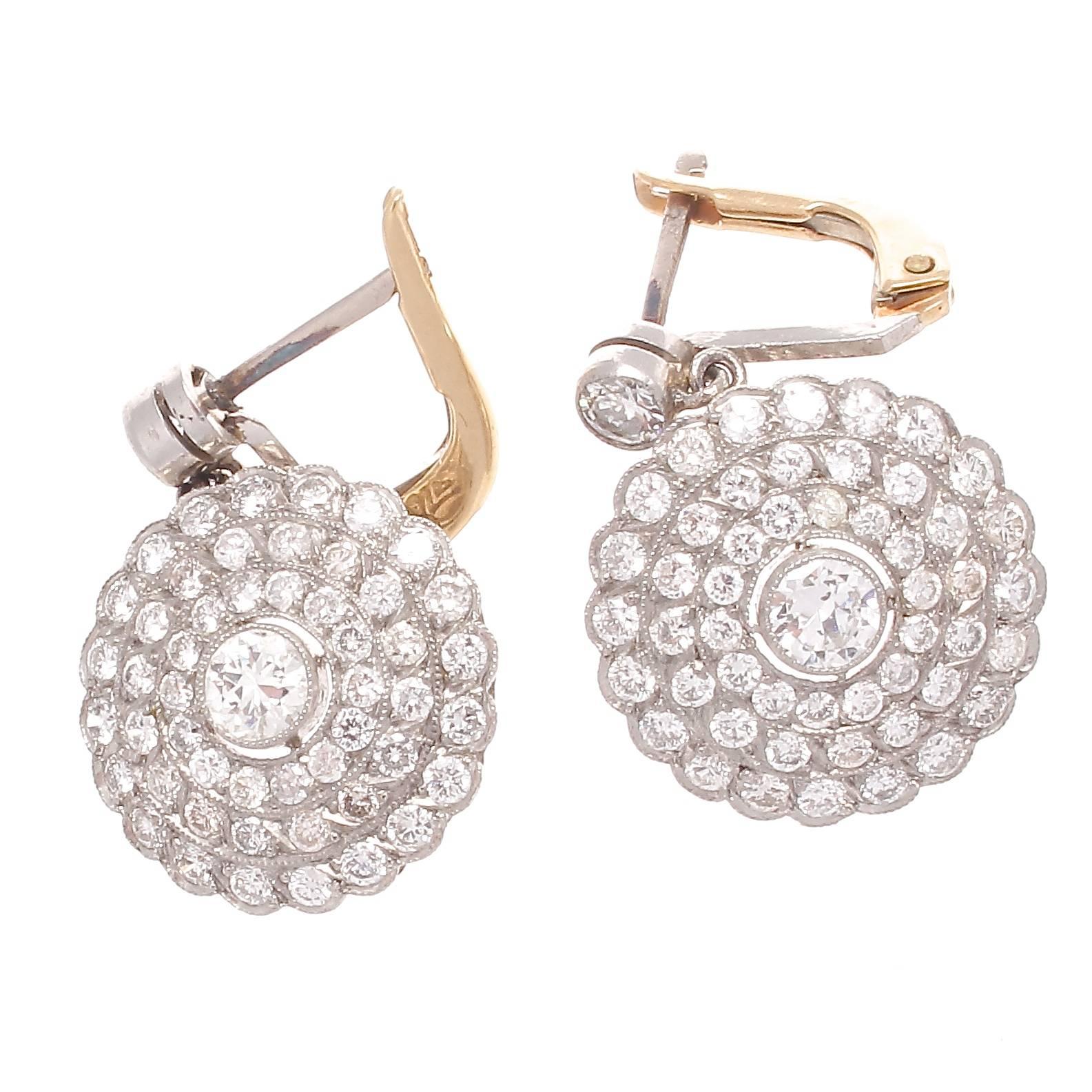 Embodying the style and allure associated with the art deco time period. Featuring numerous near colorless diamonds brilliant and sparkling making up the dangling discs. Crafted in platinum.