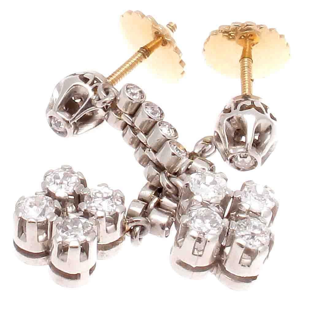 Art deco excellence has inspired this lovely creation. Featuring 9 diamonds in each earring that float down to the elegant floral drop. Each earring weighing approximately 0.65 carats each for a total approximate carat weight of 1.30. Hand crafted