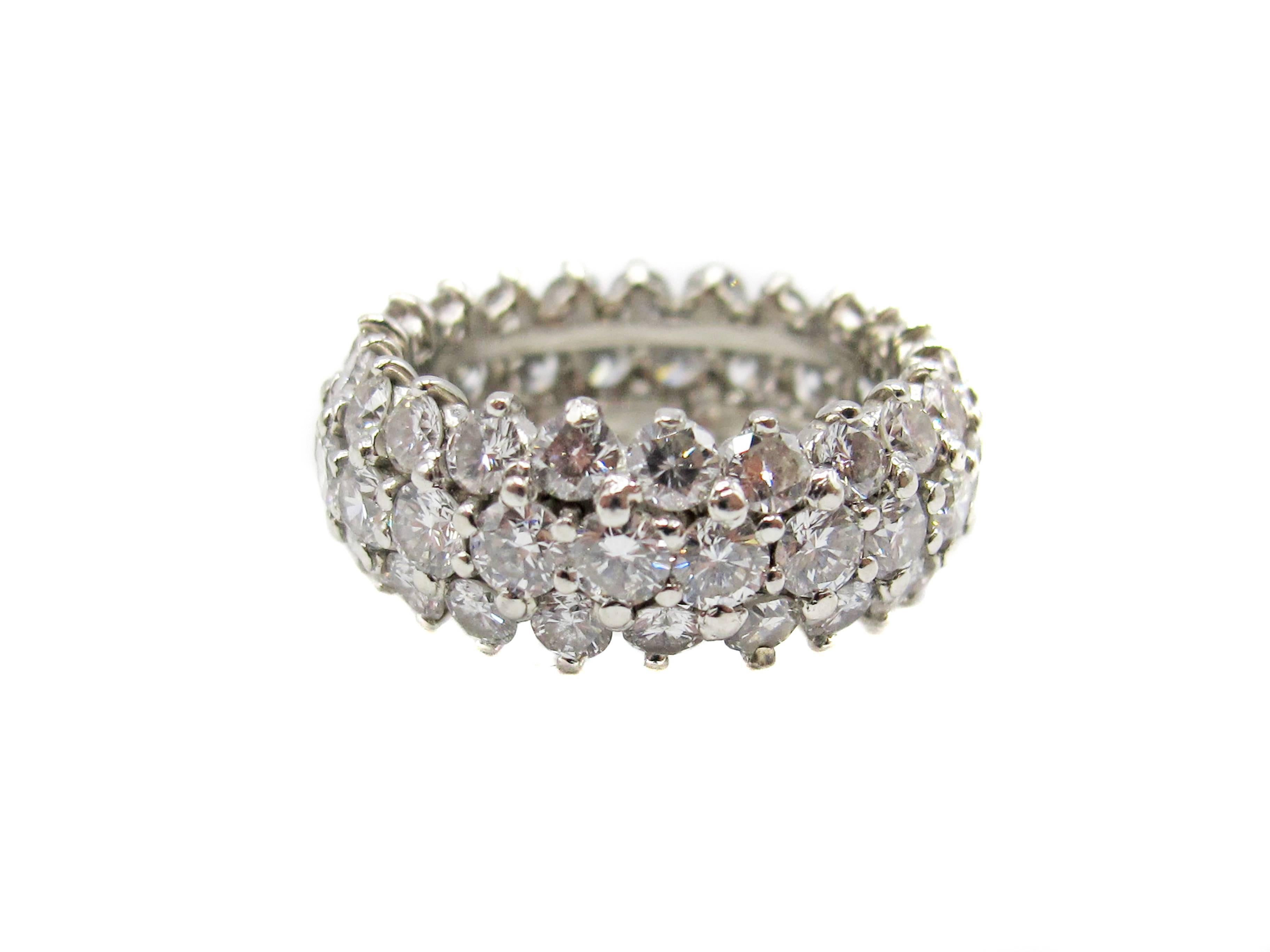 
This extremely well handcrafted platinum diamond eternity band is set with 66 bright, white and sparkly round brilliant cut diamonds. The diamonds are all perfectly matched in color, cut and clarity. The average color of the diamonds is