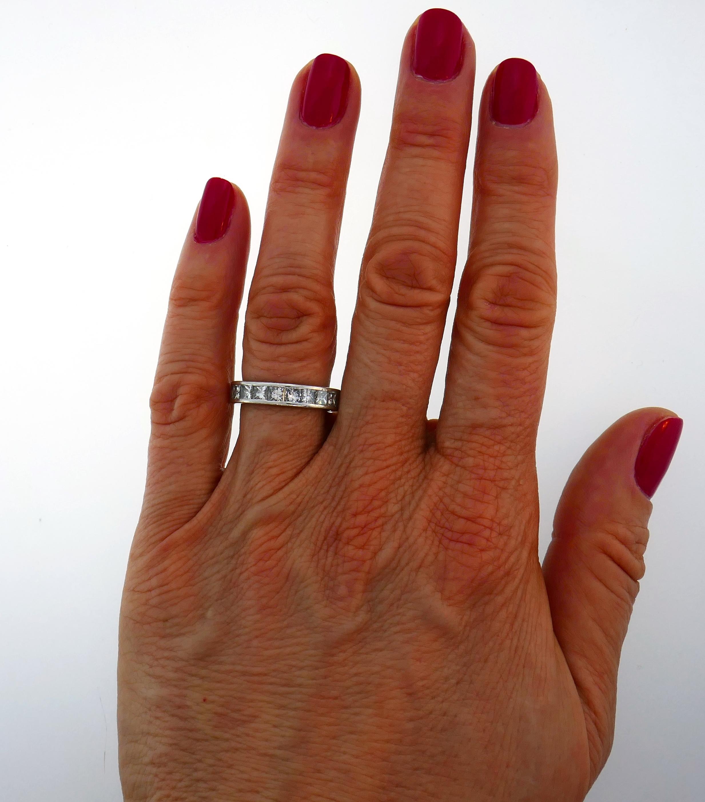  Classy and timeless diamond eternity band.
Made of platinum and set with twenty-three princess cut diamonds of approximately 0.15-carat each. Diamonds are G-H color VS clarity, total weight approximately 3.45 carats. 
The band is size 6, 4.3