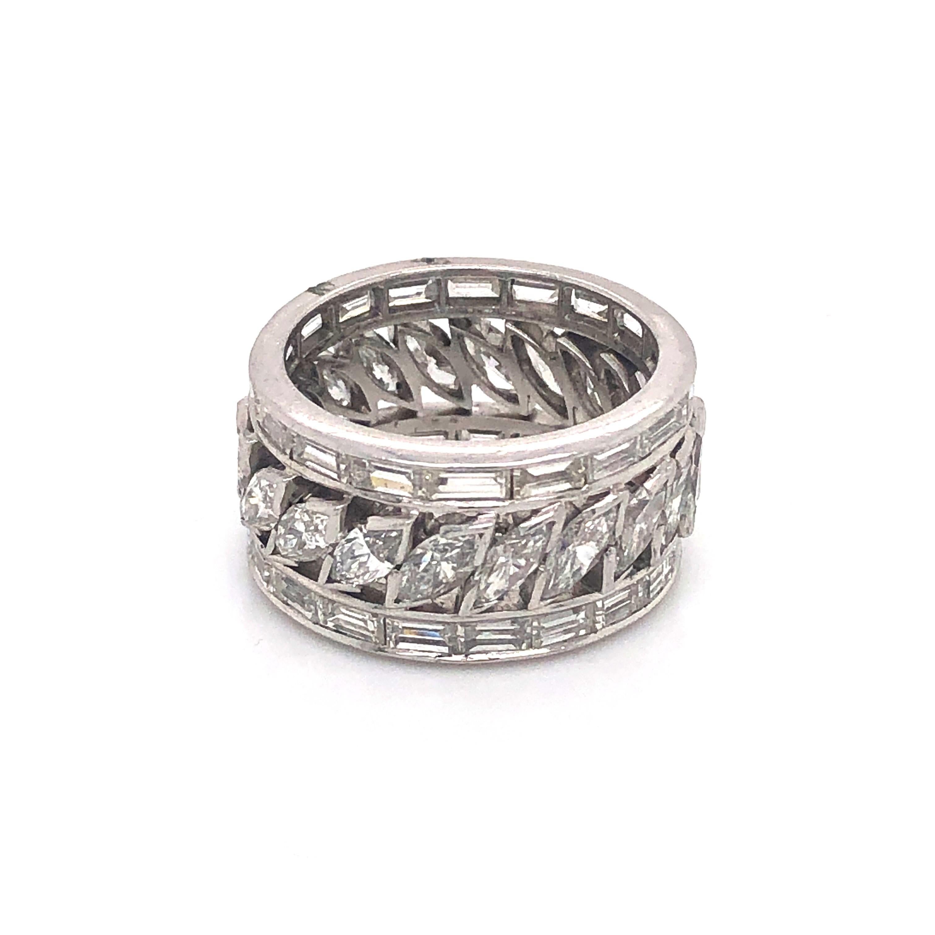 An eternity ring, set with baguette and marquise-cut diamonds, mounted in platinum. Estimated total diamond weight 4.40ct. Estimated colour G-I , estimated clarity SI-VS.
UK finger size L / USA 5¾.