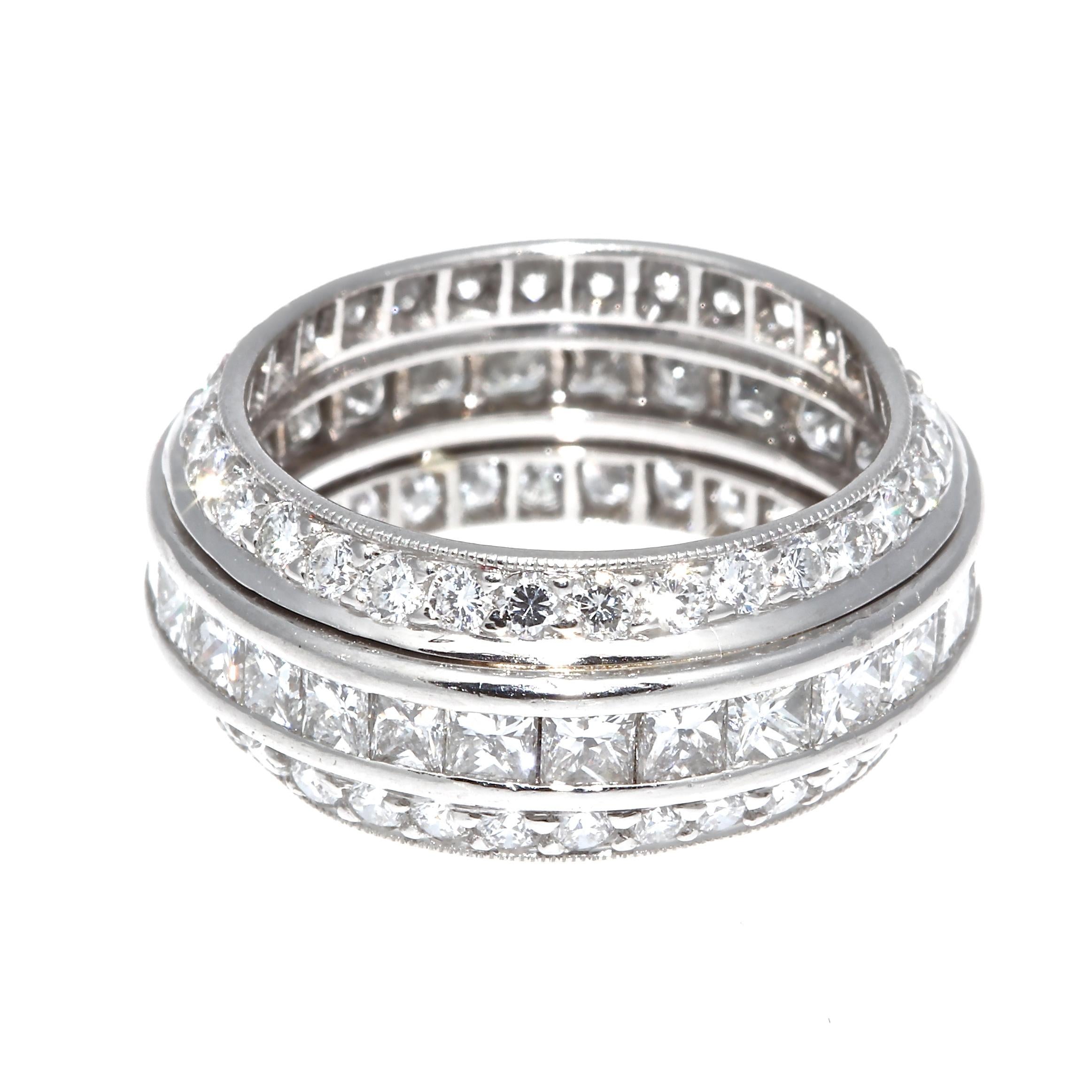 Timeless elegance radiates from this diamond platinum eternity band. Featuring a fascinating combination of 29 princess cut diamonds infused with two round cut dimaond bands weighing approximately 3.50 carats total and are H-I color, VS+ clarity.