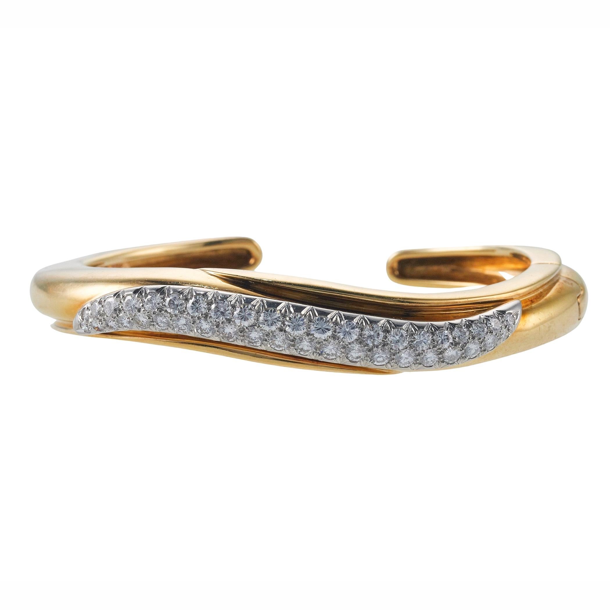 18k yellow gold and platinum wave cuff bracelet, set with approx. 2.50ctw in VS-SI/G-H diamonds. Bracelet will fit approx. 7
