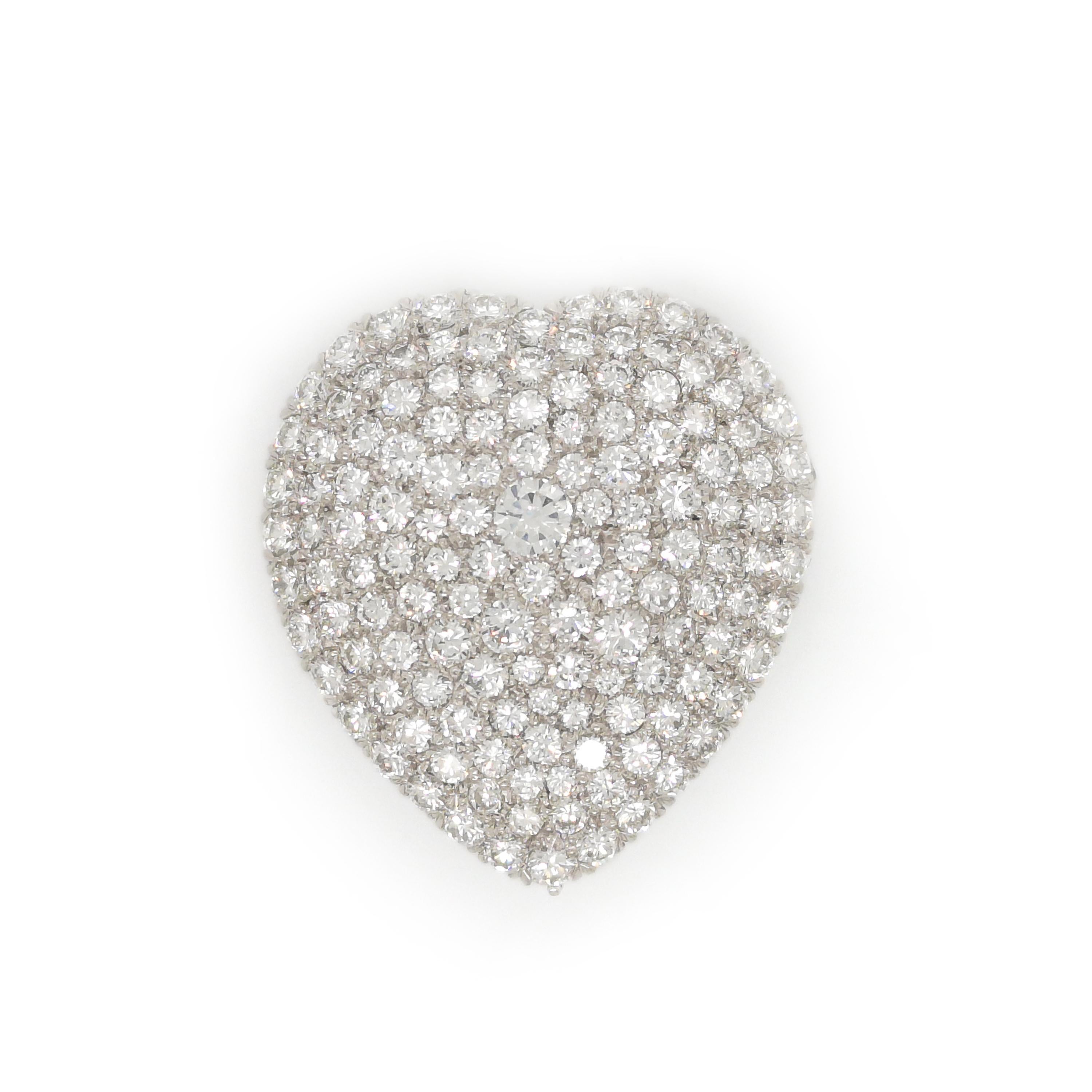 A diamond set heart shape pendant brooch, pavé set with round brilliant-cut diamonds, weighing an estimated total of 5.35ct, mounted in platinum, with shepherd hooks to attach a chain and a brooch pin. In our opinion the diamonds are colour G-H,