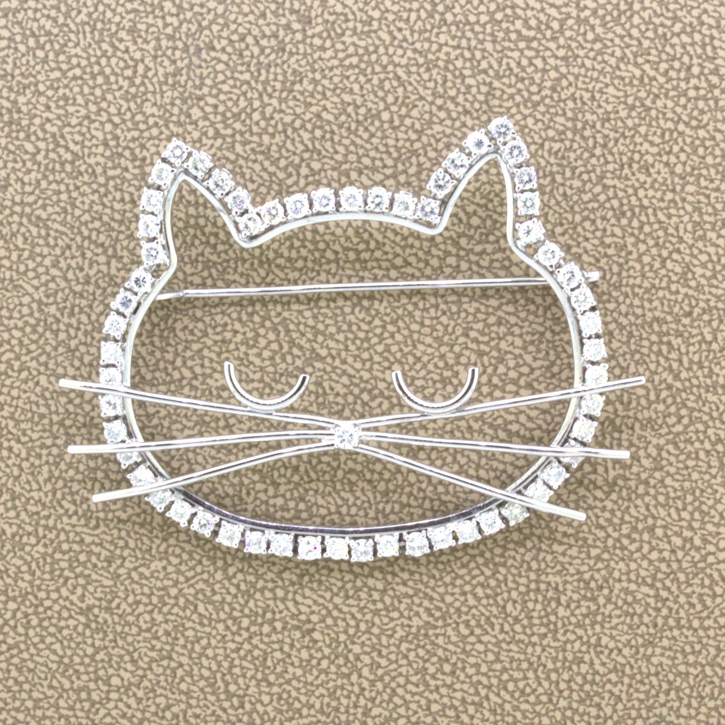 A sweet and stylish brooch of a sleeping kitty cat! It features 2.61 carats of round brilliant-cut diamonds set around the border of the piece as well as used for the nose of the cat. Platinum whiskers radiate from its center giving the piece extra
