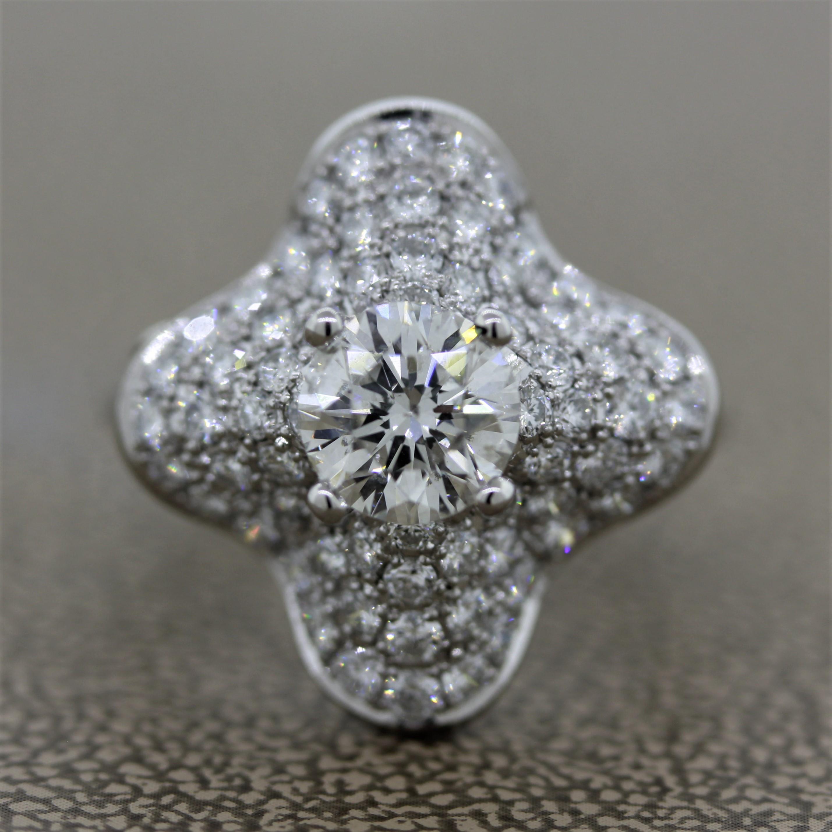 A sweet diamond ring featuring a 1.08 carat round brilliant cut diamond in the center. Surrounding the center diamond are an additional 0.86 carats of round brilliant cut diamonds which are pave set around this platinum clover ring. The center