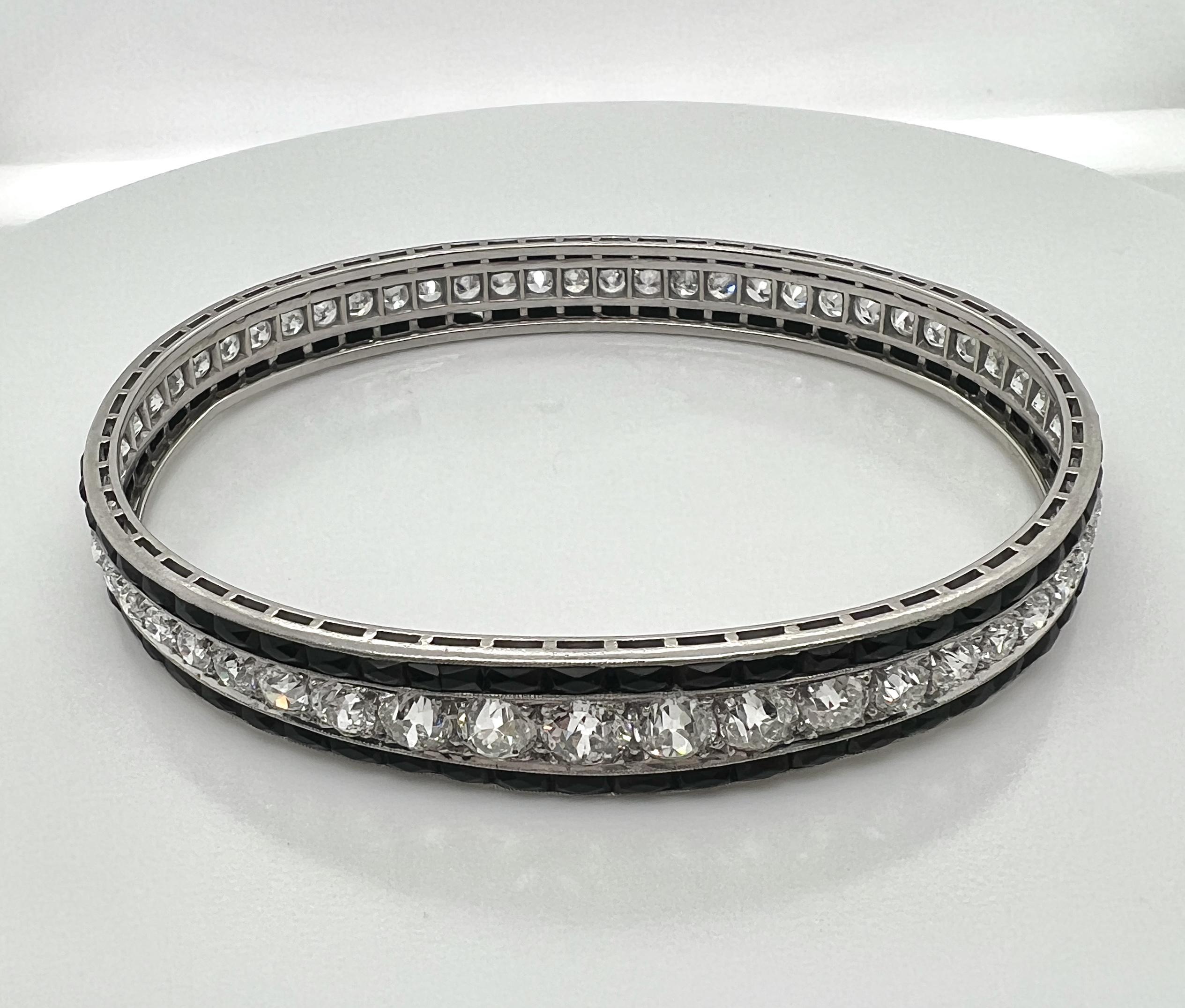 Diamond Platinum Onyx Bangle Style art-deco Bracelet.

Set with fifty-eight European cut diamonds in center tapering from approximately .65 carats at center to .25 carats at bottom of bracelet, approximately total carat weight is 15 carats by