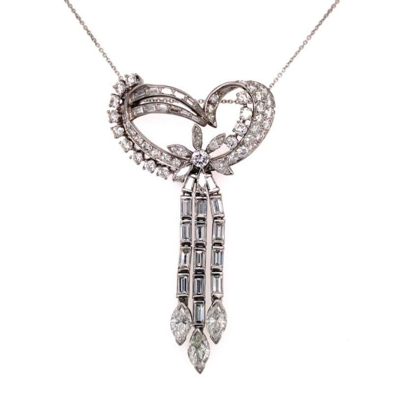 One diamond platinum pendant featuring a total of 81 marquise, straight baguette and round brilliant cut diamonds totaling 6 ct. Designed as an abstract open heart motif with dangling moveable portions. Circa 1950s.

Abstract, gorgeous,