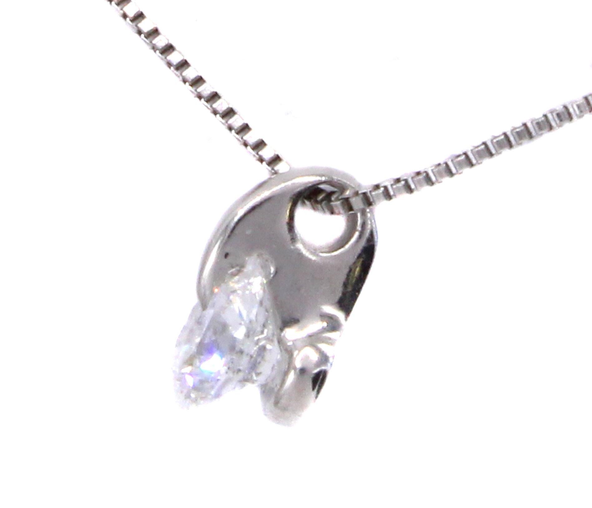 An extremely white and bright round brilliant cut diamond is uniquely set in this platinum handcrafted pendant necklace. With a platinum curved claw extending to the table of the diamond which is securely held in a cub, the diamond shows its full