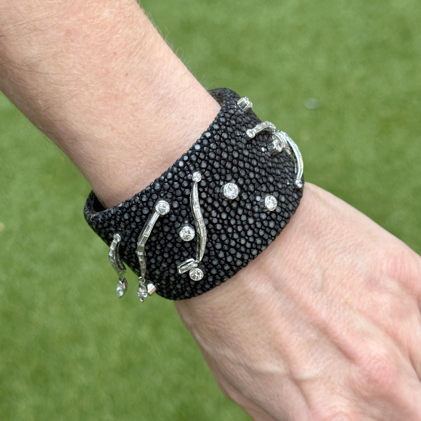 This unique cuff bracelet combines modern luxury with bold design, featuring a striking stingray skin band accented by platinum elements. The bracelet is set with a mix of round brilliant, marquise, and baguette cut diamonds totaling 3.00 carats.