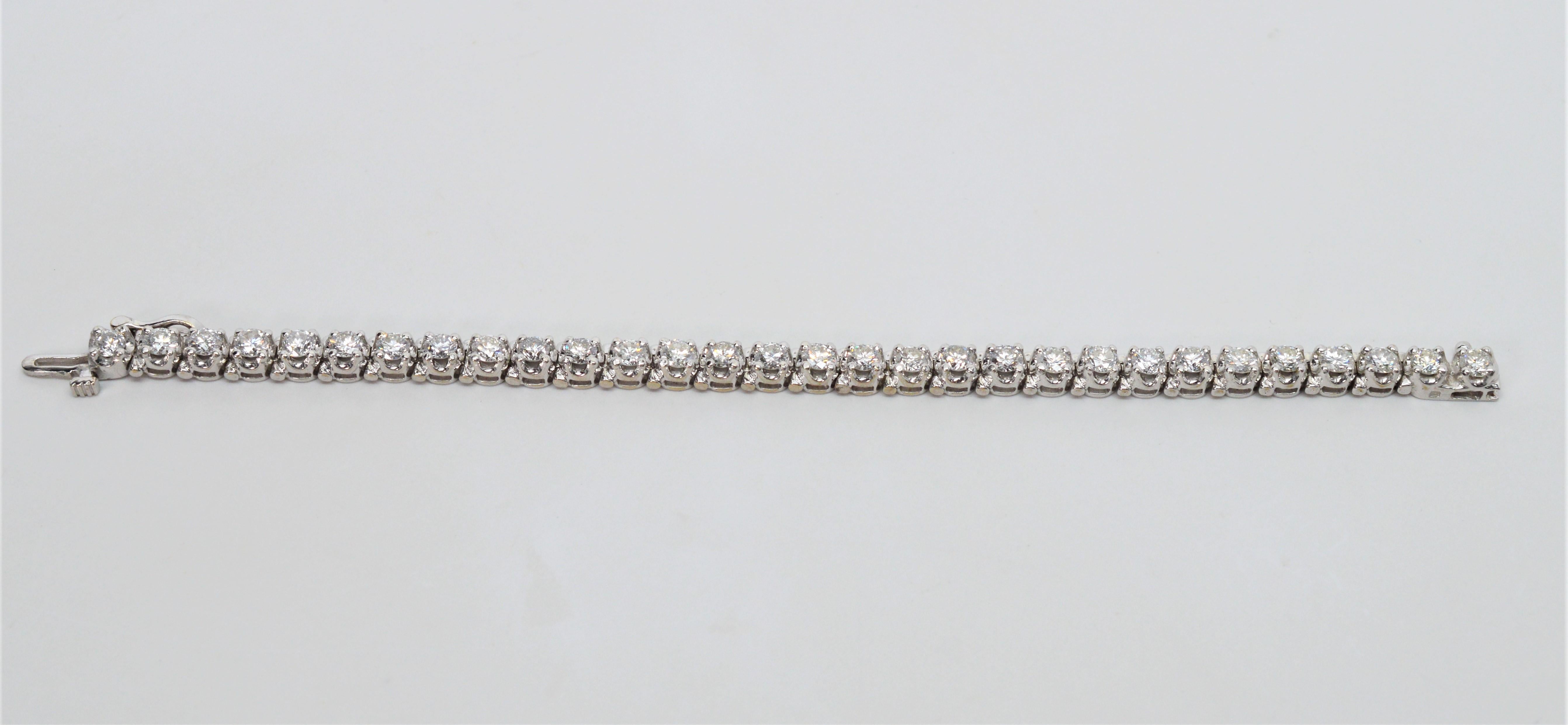 Six inches of diamonds sparkle on this elegant,  custom-made tennis bracelet. Thirty .25 carat H/SI diamonds are prong set in platinum for a total weight of 7.5 carats that are sure to get noticed. Six inches in length and outfitted with a lock and