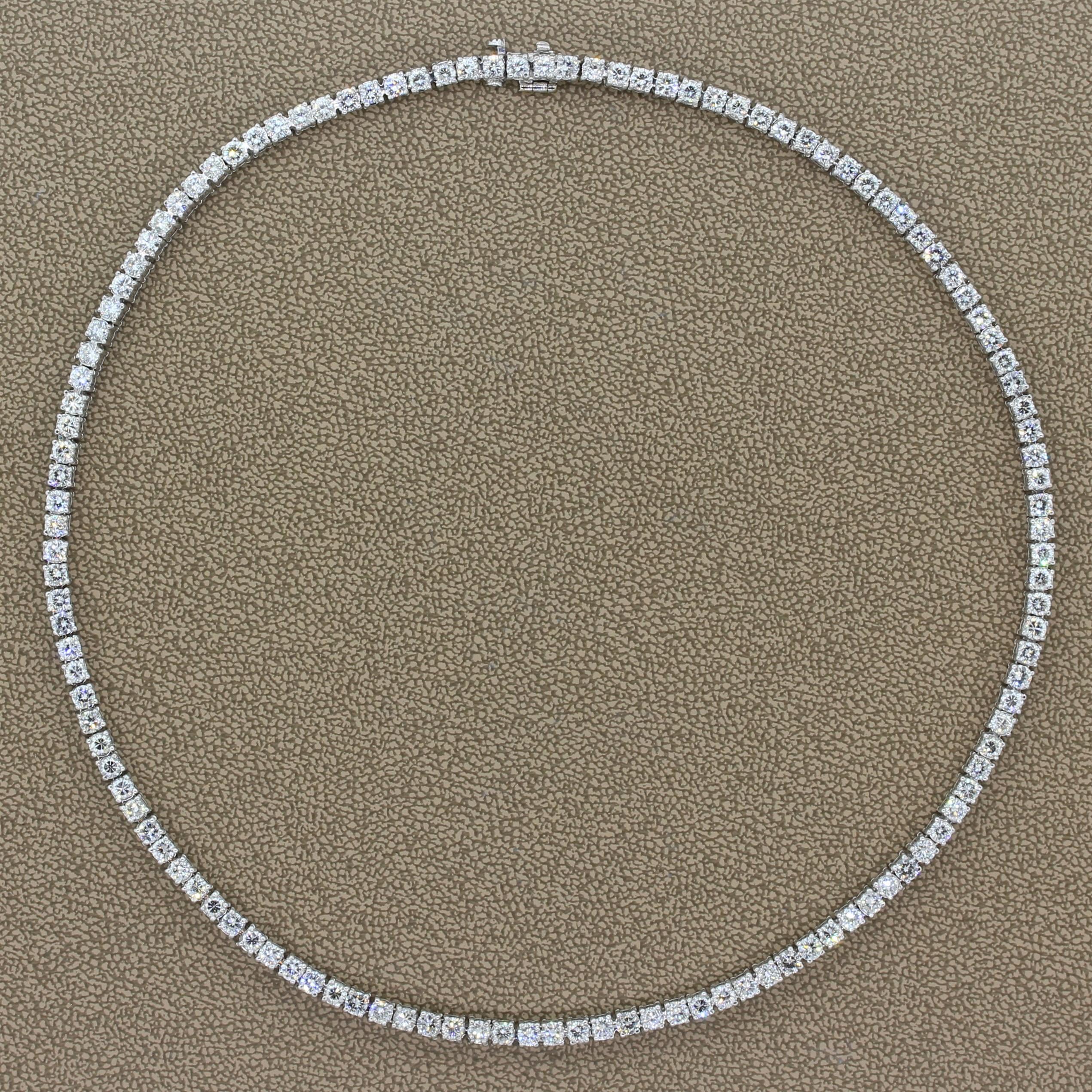 A classic tennis necklace featuring 12.90 carats of diamonds. The colorless round cut diamonds are prong set in luxurious platinum. A seamless closure is provided by a hidden safety latch for safe keeping. 

Necklace Length: 15.00 inches 
Necklace