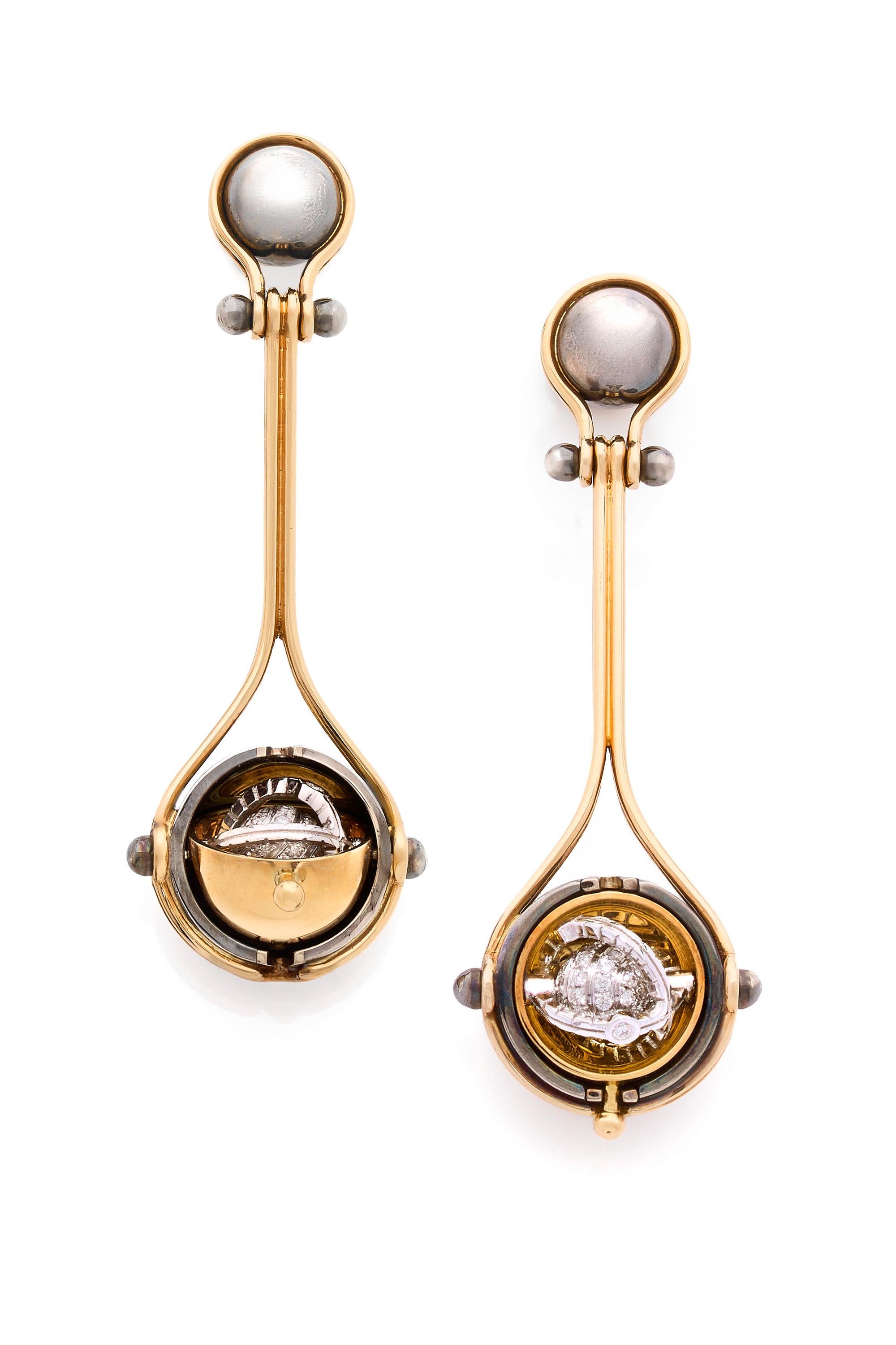 Yellow gold and distressed silver earrings. Rotating spheres revealing a planet of diamonds, encircled by a white gold ring, set with a diamond.  

Details:
124 Diamonds: 0.72 cts 
18k Yellow Gold: 14 g
Distressed Silver: 5 g
Made in France