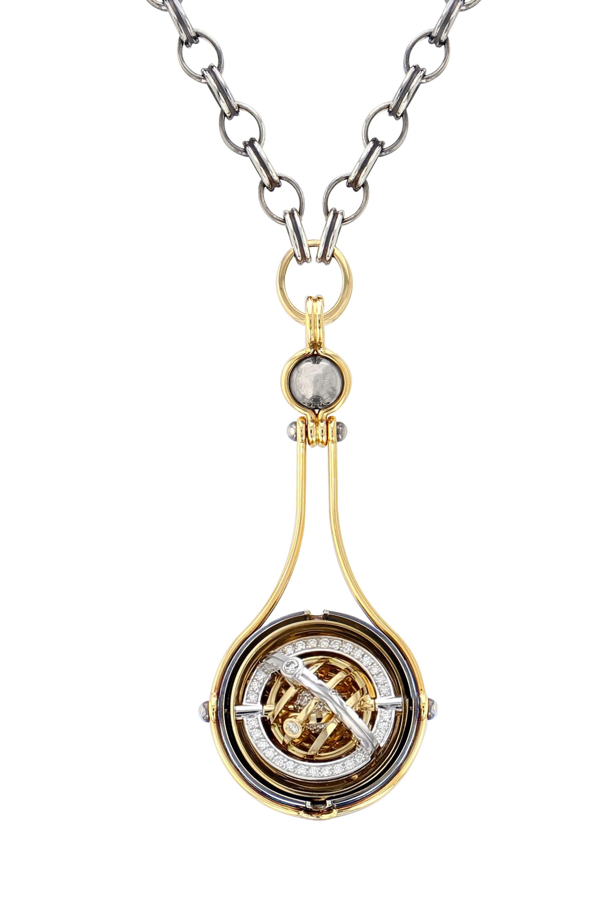 Yellow gold and distressed silver pendant. Rotating sphere revealing a planet of diamonds encircled by a set of mobile rings in yellow and white gold, set with diamonds.

Distressed silver chain.

Details:
Diamonds : 1.7 cts 
18k Yellow Gold : 50