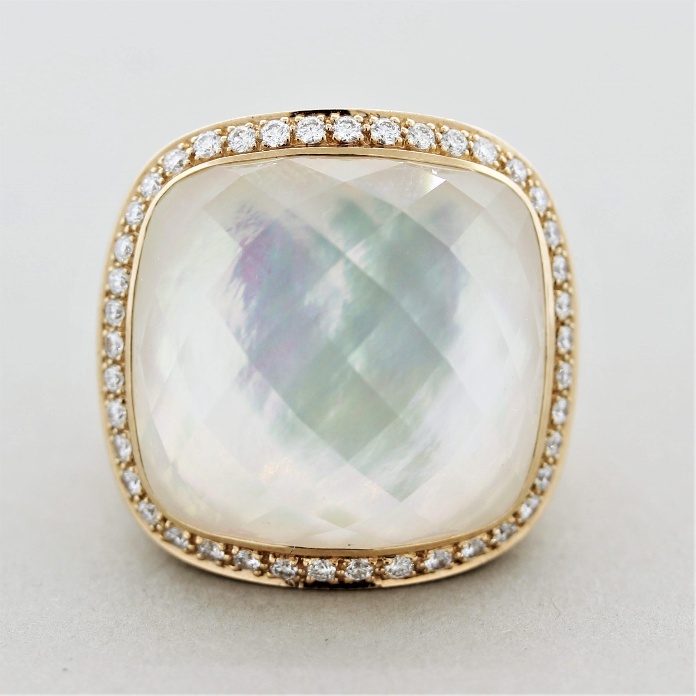 A big bright and stylish cocktail ring featuring an array of multi-colors. The ring features a 27.03 carat rose-cut quartz crystal which is set over a base of mother-of-pearl displaying strong iridescence (natural color phenomenon). This lovely