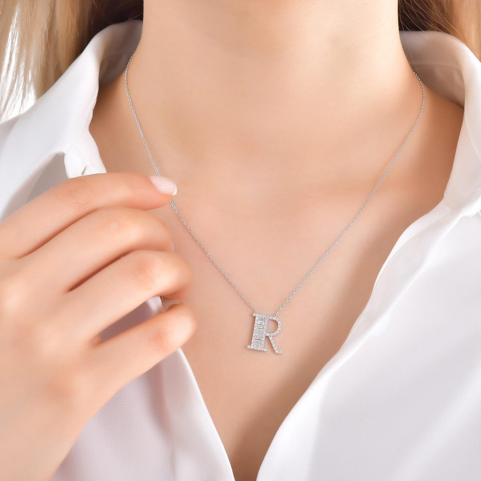 This Beautiful Baguette Diamond Letter Pendant Is Entirely Handcrafted In 14 Karat White Gold. 
The Letter R Pendant Is Garlanded With Channel-Set Baguette-Cut Diamonds And Prong Set Brilliant Round Diamonds Weighing 0.47 Carats. All Of The Stones