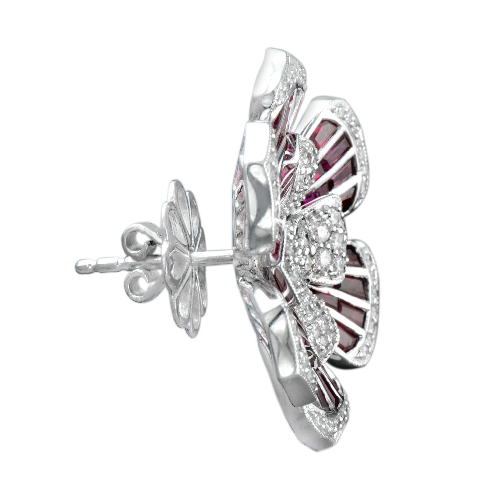 Shine bright with these stunning diamond and ruby earrings. The earrings features 146 round cut diamonds and 96 French cut rubies. These earrings are fresh, classical and a feminine piece of wearable art. 14K White Gold. 
Information
Width: 23