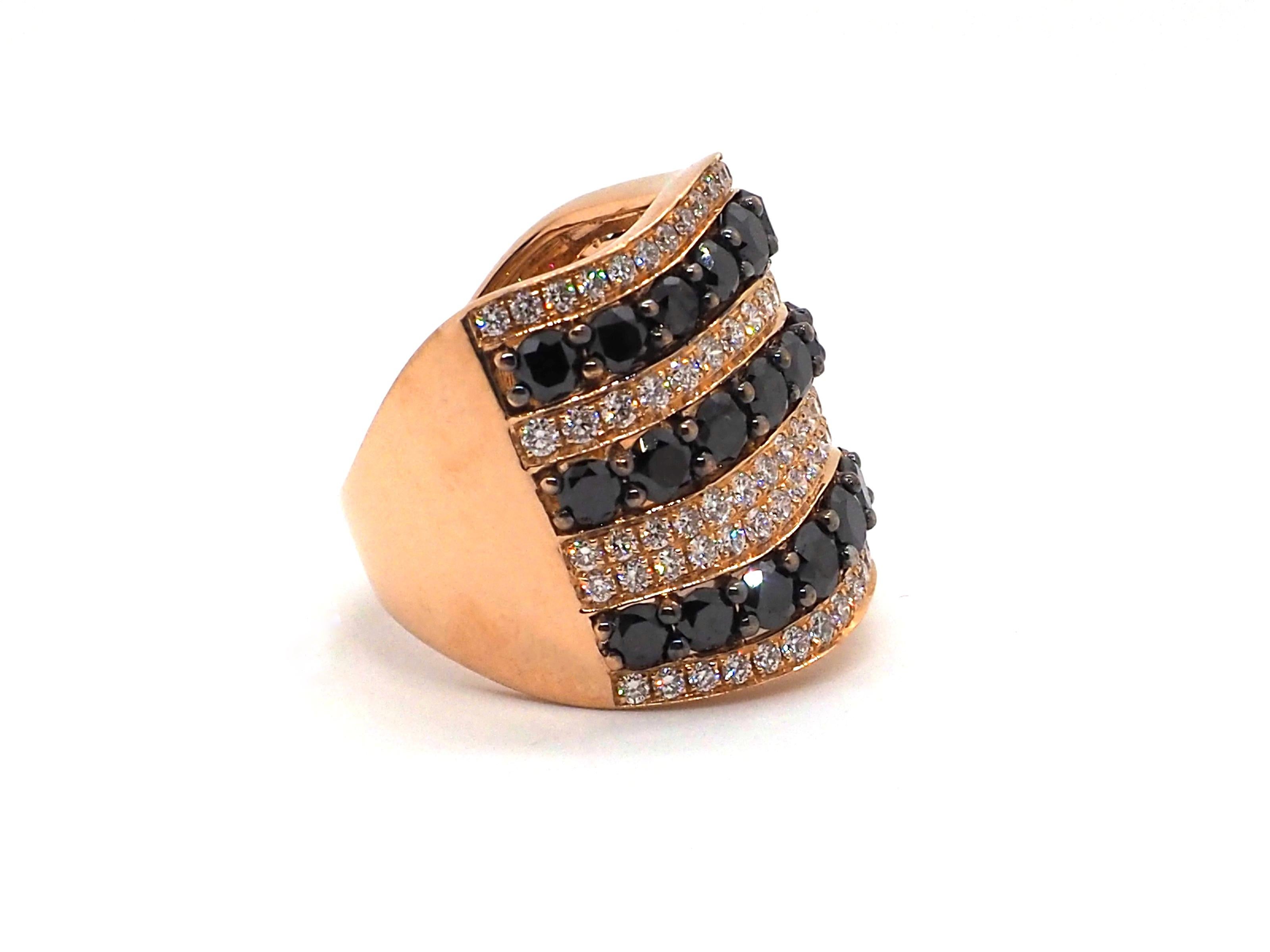 A beautiful cocktail ring crafted in 18 K rose gold. It is decorated with black ( about 3 carats) and white (1 carat) diamonds which form an ornament consisting of wavy lines.

Total weight: 11 grams
EU size: 56
US size: 7.75

The ring is in perfect