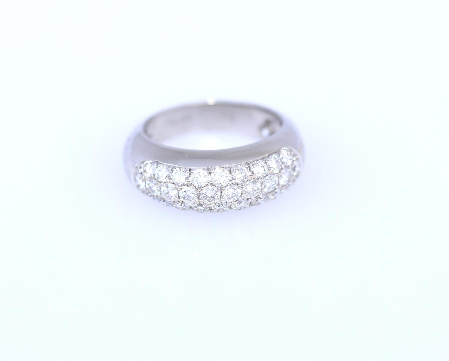 1.3 Carats of fine round cut Diamonds in an 18K White Gold ring.

The design is timelessly classic. Rows of fine Diamonds are facing upwards. The ring itself has a substantial band, with Diamonds fixed on top with the use of an “invisible”