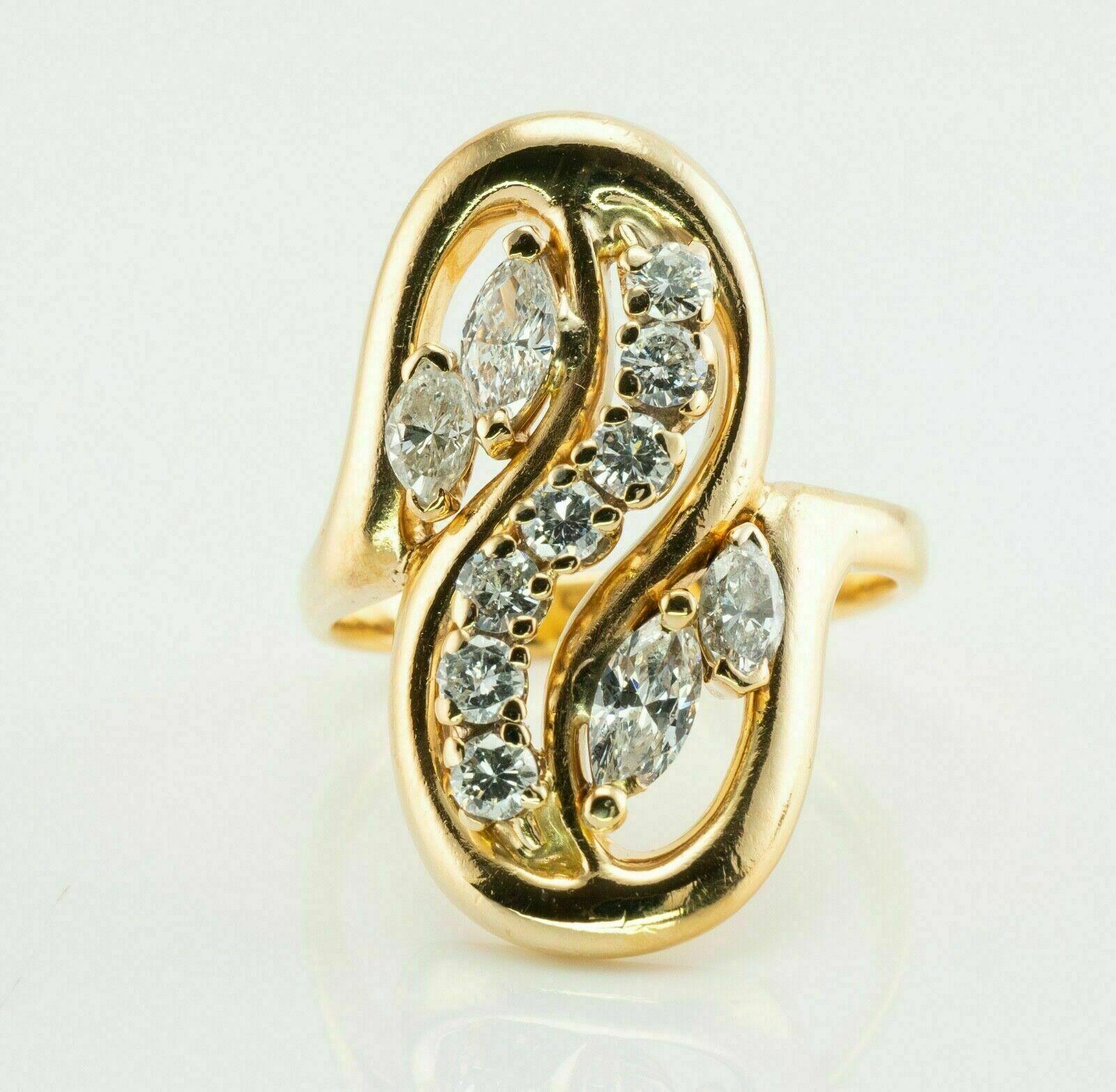 This vintage diamond ring is crafted in solid 14K Yellow Gold (carefully tested and guaranteed). The ring holds four marquise cut diamonds and seven round brilliant cut diamonds. Two marquise are .50 carat total, two smaller marquise are .36 carat