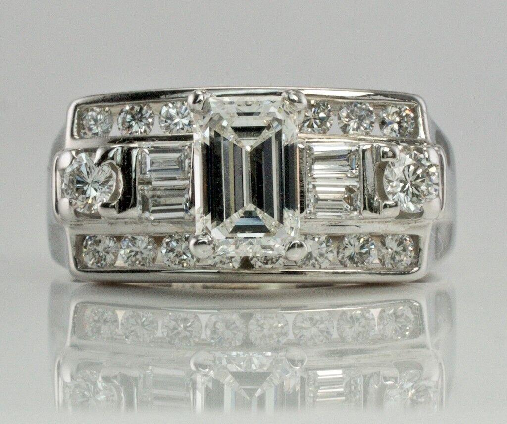 This gorgeous Vintage elegant ring is finely crafted in solid 14K White Gold and set with white and fiery genuine diamonds. 
The center emerald cut diamond is .50 carat.
Four diamond baguettes .20 carats.
Eighteen round brilliant cut diamonds total