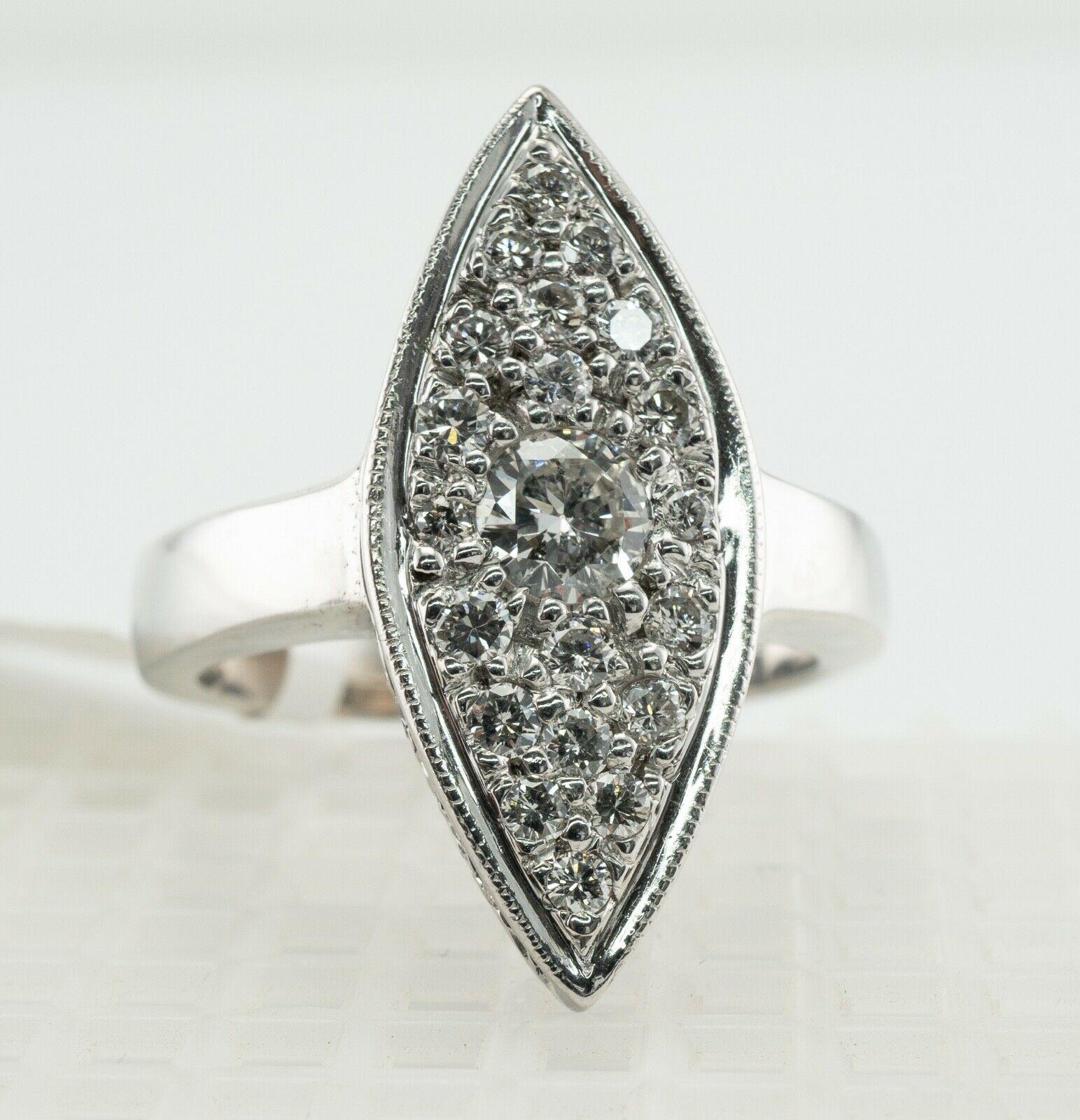 Diamond Ring 14K White Gold Vintage Marquise Shape

This vintage ring is crafted in solid 14K White Gold (carefully tested and guaranteed).
It still has a $3480 tag from estate auction.
The center round brilliant cut diamond is .20 carat of I2