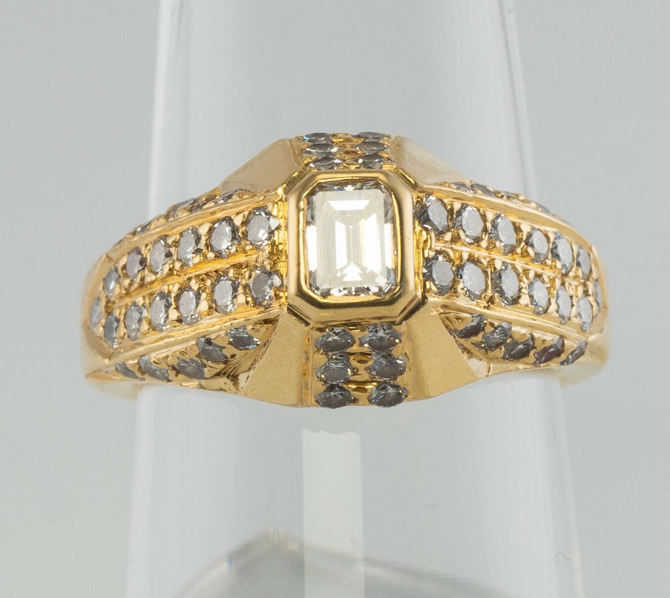 This stunning estate piece is finely crafted in solid 18K gold and set with wonderful whitest diamonds. The band is hallmarked with T inside C. The center emerald cut gem measures 4mm x 3mm (.19 carat). Fifty-eight round brilliant cut diamonds add