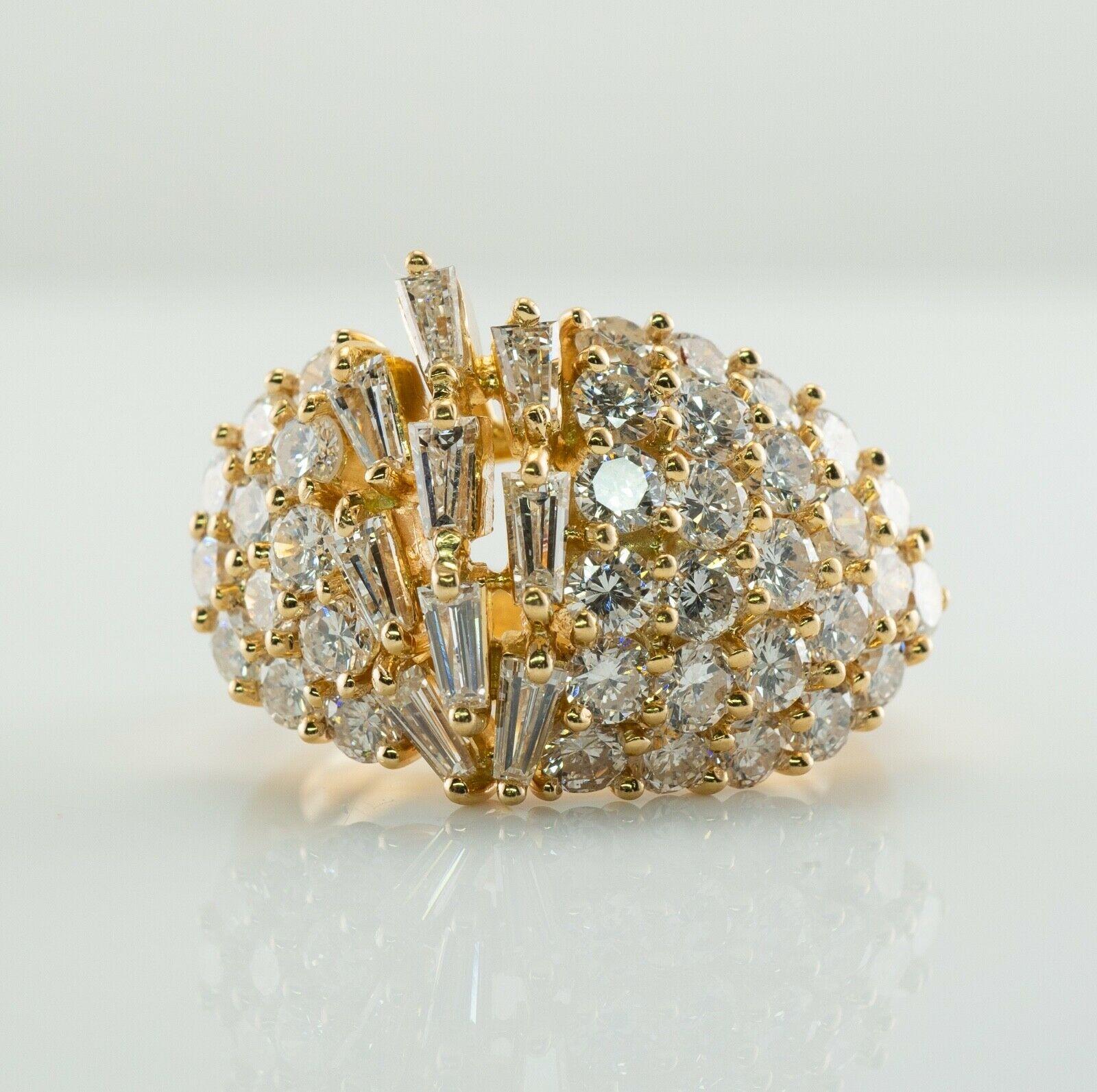 This incredible ring is finely crafted in solid 18K Yellow Gold. Twenty five on one side and twelve diamonds on another side are round brilliant cut gems totaling 1.70 carats. Nine tapered diamonds total .45 carat. The grand total for all diamonds