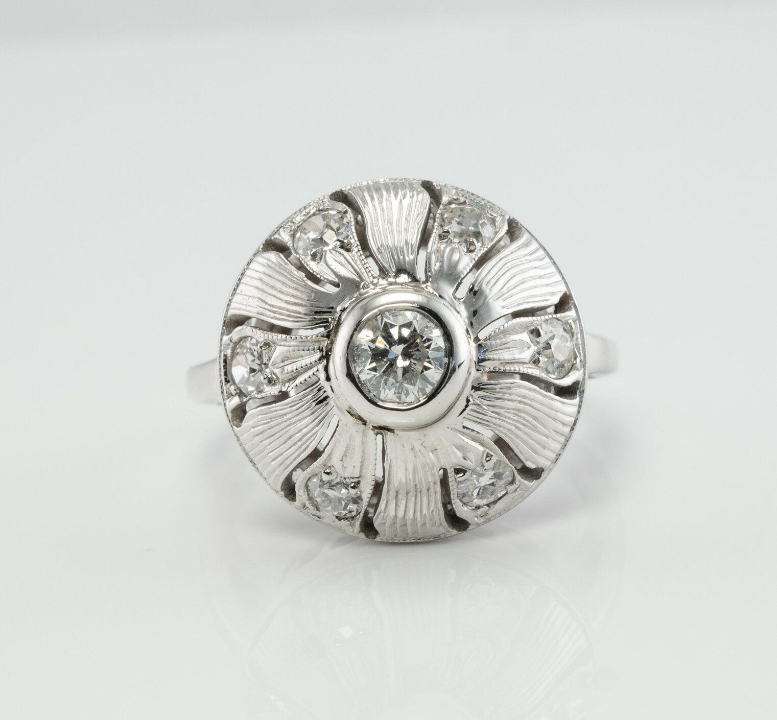 This amazing vintage ring is finely crated in solid 14K White gold and set with white and fiery diamonds. The center bezel-set diamond is .25 carat, six mine cut surrounding diamonds total .30 carat. The diamonds are estimated to be VS1 - SI1