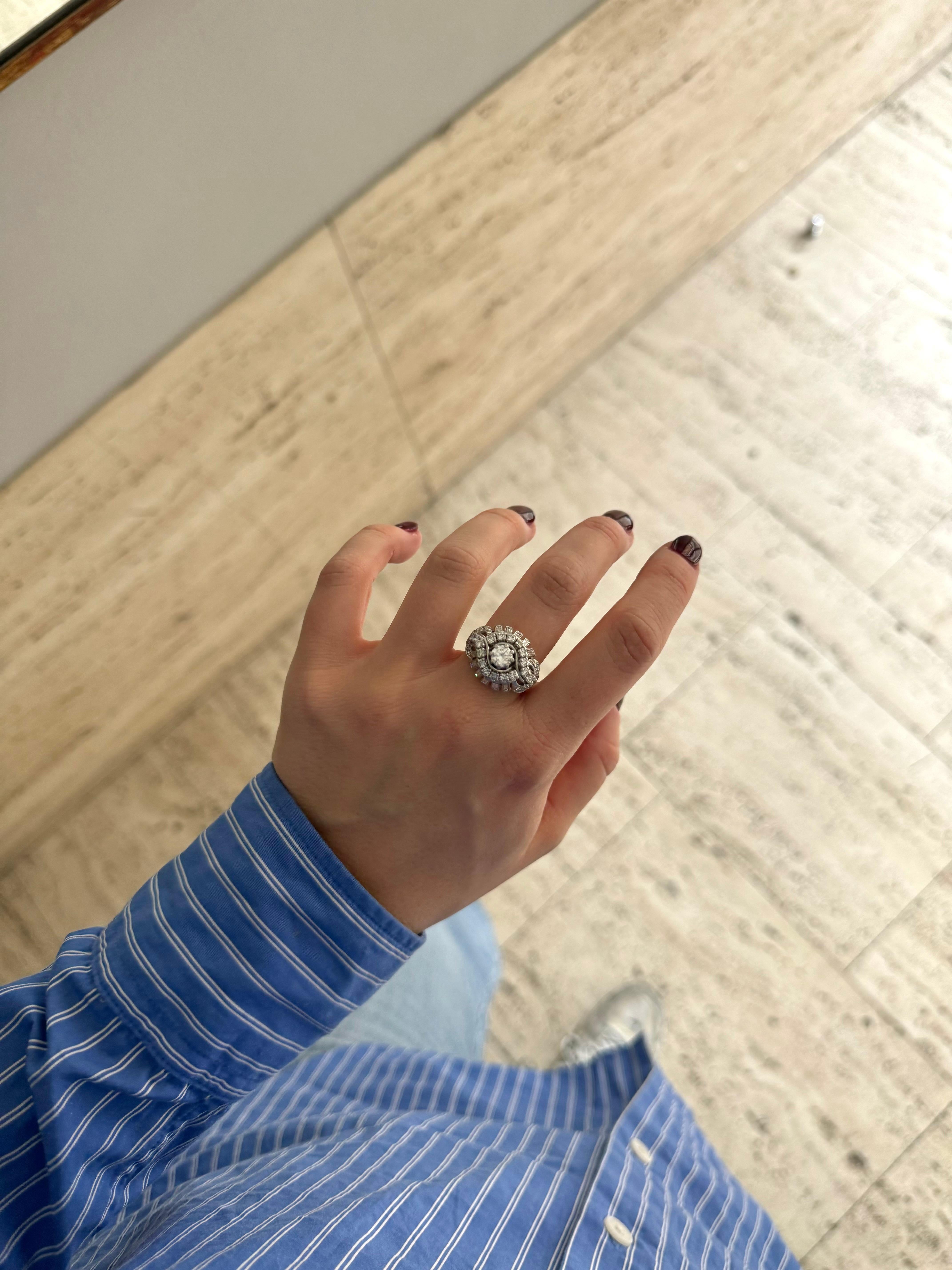 Unique Diamond cocktail ring circa 1970. 

The body of the ring is made of white gold 18 Karat and the top of the ring is made of platinum. The body of the ring is made of 4 bands shrinking together. 

The ring is set with a center full cut diamond