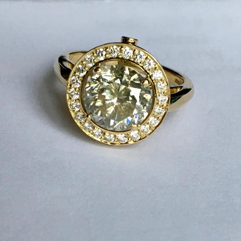 Single Stone Diamond Ring with Diamond Halo. A fabulous 3 carat fancy coloured  diamond ring set in 18 carat yellow gold with a pavé set diamond halo surround. Please note this item is made to order and a similar but not identical piece can be made.