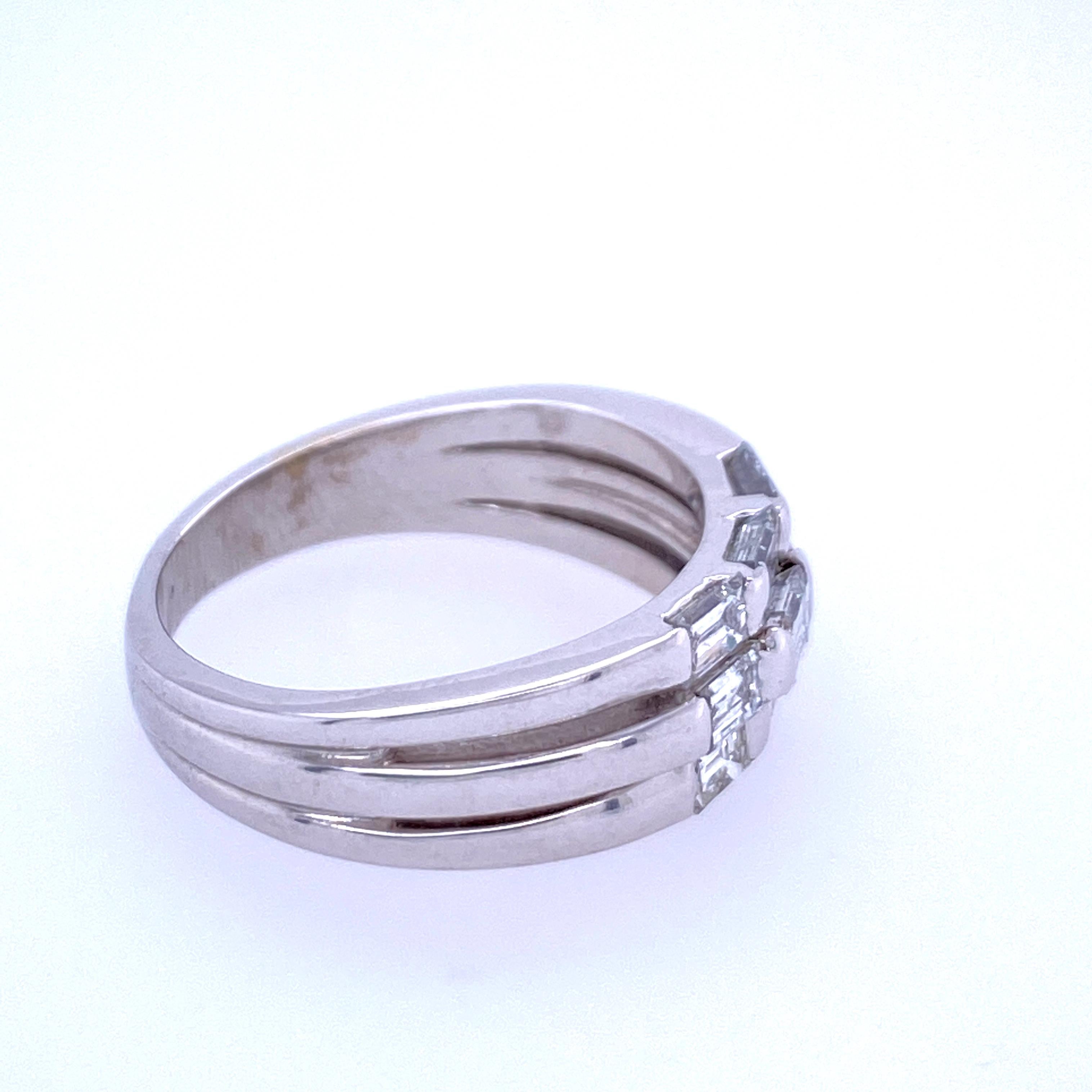 One 14 karat white gold (stamped 14K) three row ring, each row bar set with three straight baguette diamonds, approximately 1.20 carats total weight with matching H/I/J color and VS2-I1 clarity. The ring measures 6.95mm at the top and tapers to