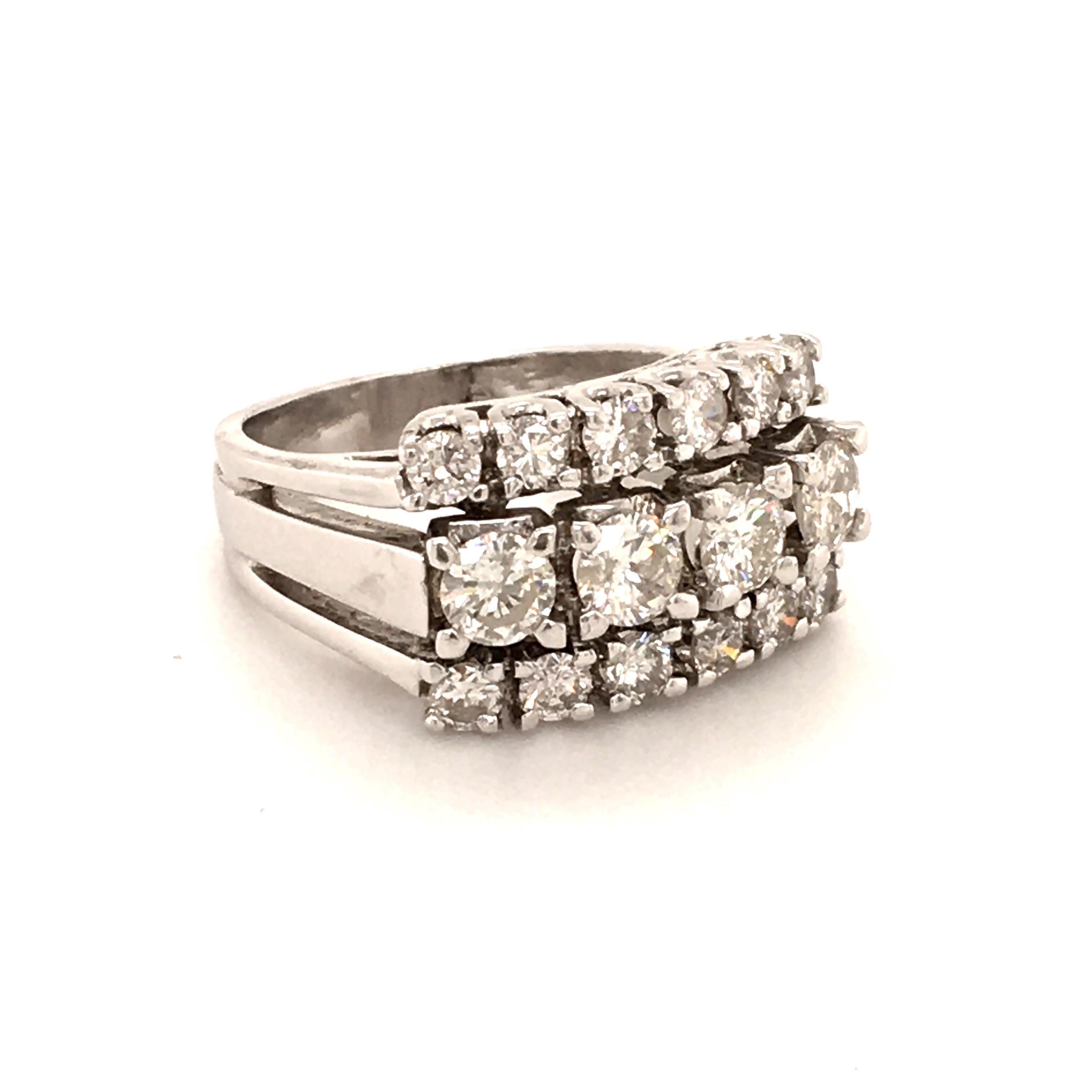 This diamond ring in white gold 14K is designed as three parallel lines set with round brilliant-cut diamonds. 
The middle row consists of four stones totalling approximate 0.88 ct, the two outer lines consist of 12 stones totalling approximate 0.60