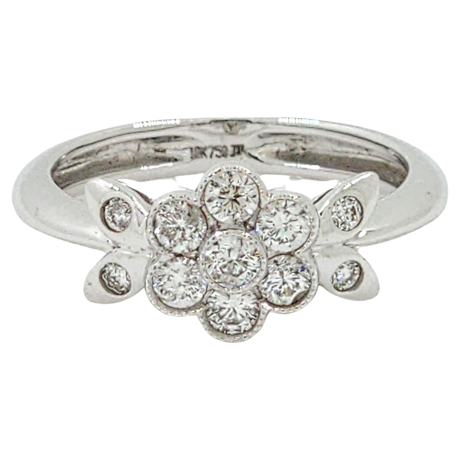 Delicate and feminine, this elegant ring celebrates the beauty of nature with a floral-inspired cluster design. Crafted in luminous 18 karat white gold, the centerpiece features 0.48 carats of white round diamonds arranged in a charming daisy-like