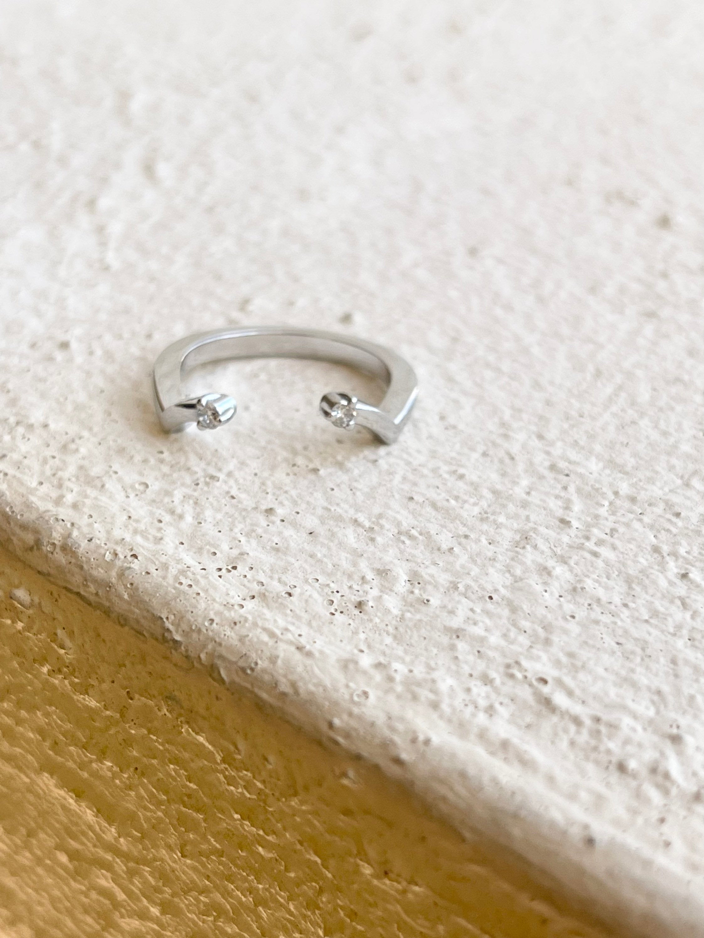 A versatile ring called Negative Space, super comfortable when on finger made with open concept and two diamonds VS clarity and G color, ring is made in size 5 and can be re-sized to any size. Ring is made in 18KT gold.
*Item will come with a