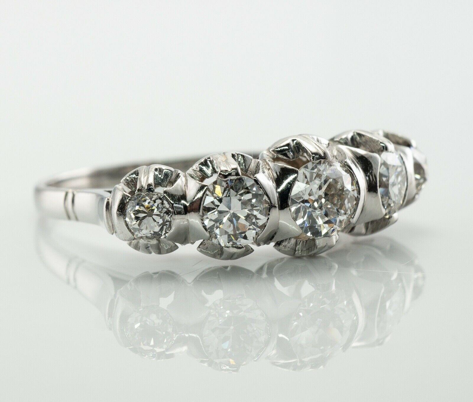 This gorgeous vintage circa 1930s ring is finely crafted in luxury Platinum (carefully tested and guaranteed) and set with old mine cut diamonds. The center diamond is .50 carat, two gems are .30 carat each, end side diamonds are .15 carat each. The