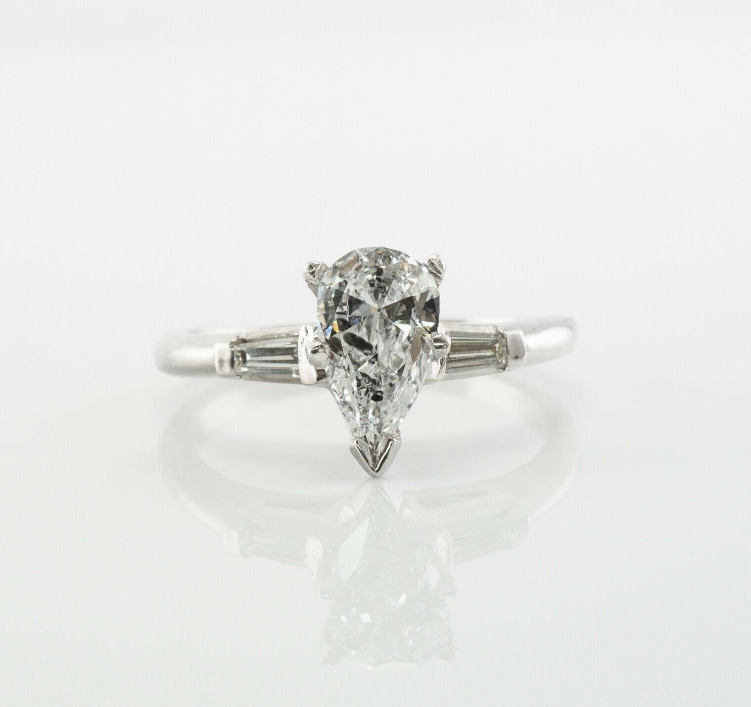 Diamond Ring Platinum Pear cut .90 TDW Engagement

This estate engagement ring is finely crafted in solid Platinum and set with natural diamonds. 
The center pear cut gem is 0.80 carats of I1 clarity and H color. 
Two accent diamonds are VS2 clarity